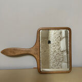 Old beveled hand mirror and wooden frame