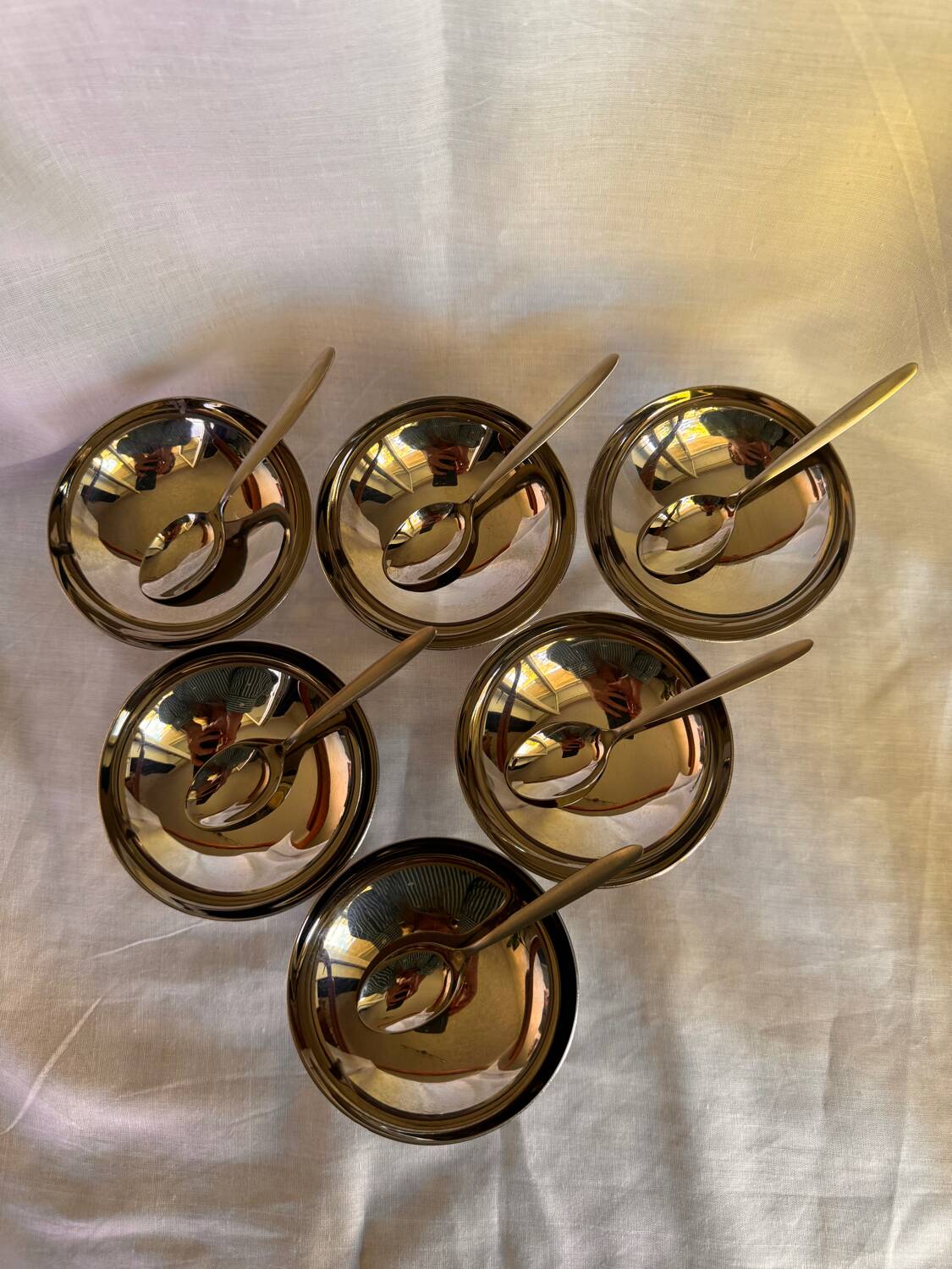 Set of 6 stainless steel ice cream bowls by Guy Degrenne with matching spoons.