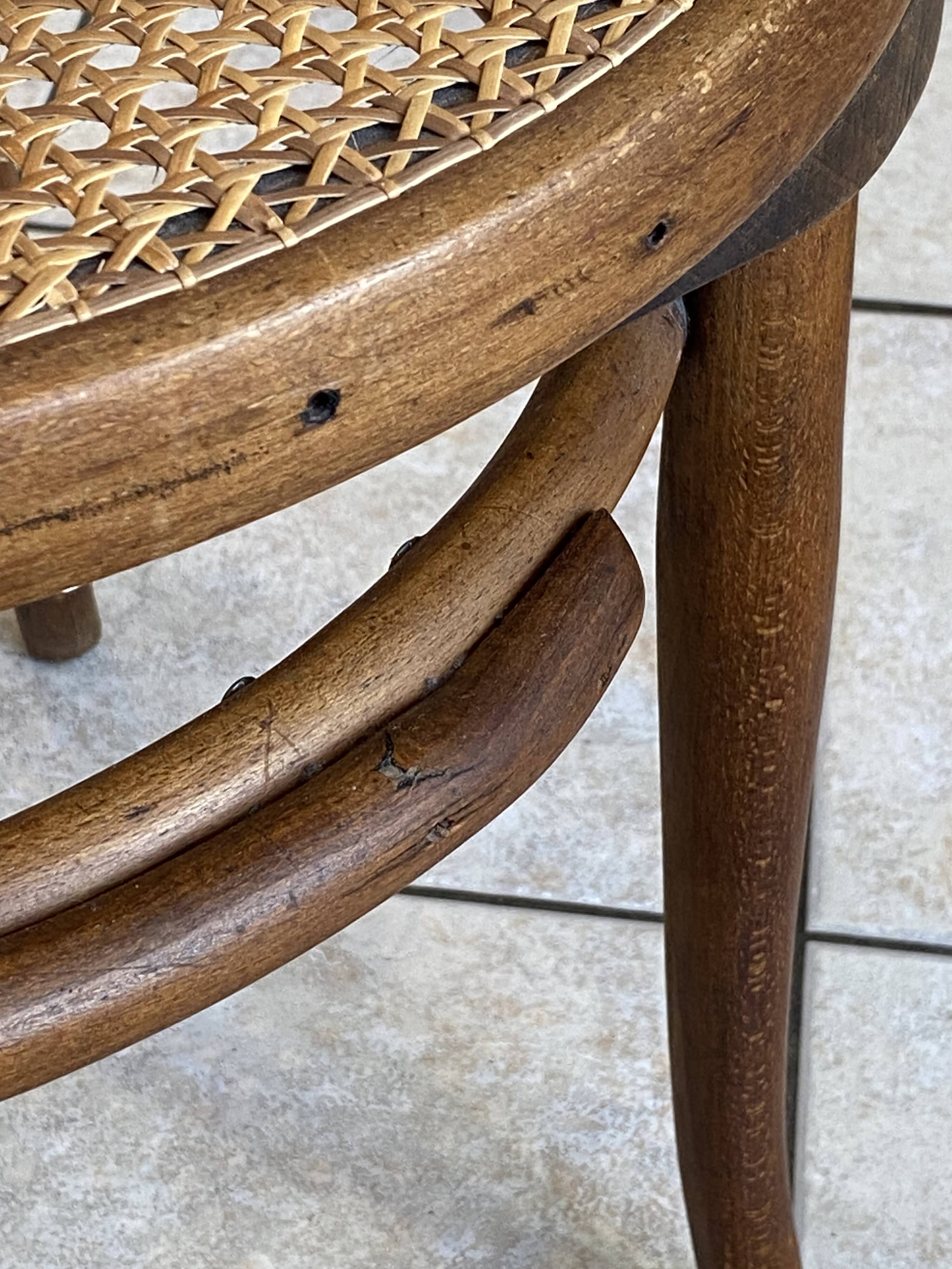 Bistro chair with a curved wooden frame and caned seat from the 1930s.
