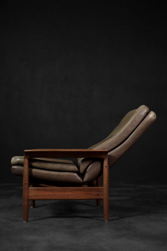 High teak and brown leather armchair with reclining backrest, mid-century Danish style, 1960s.