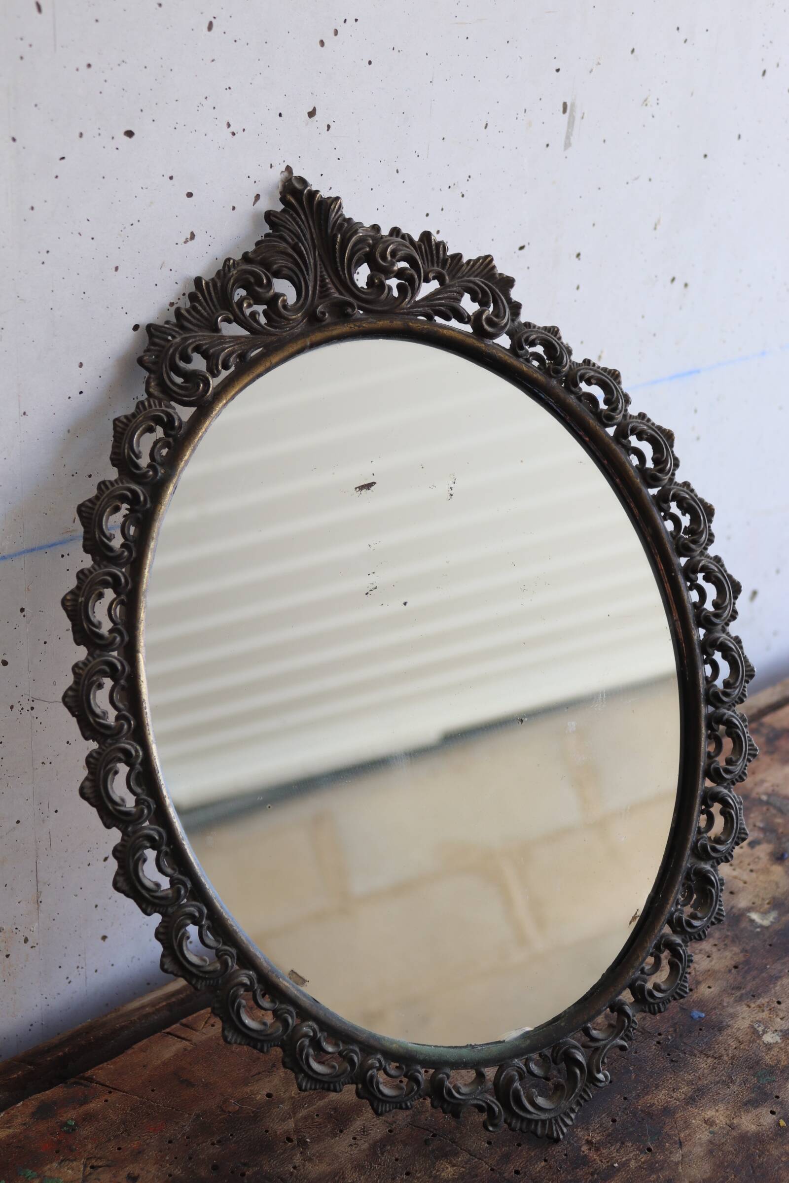 Baroque style oval metal mirror