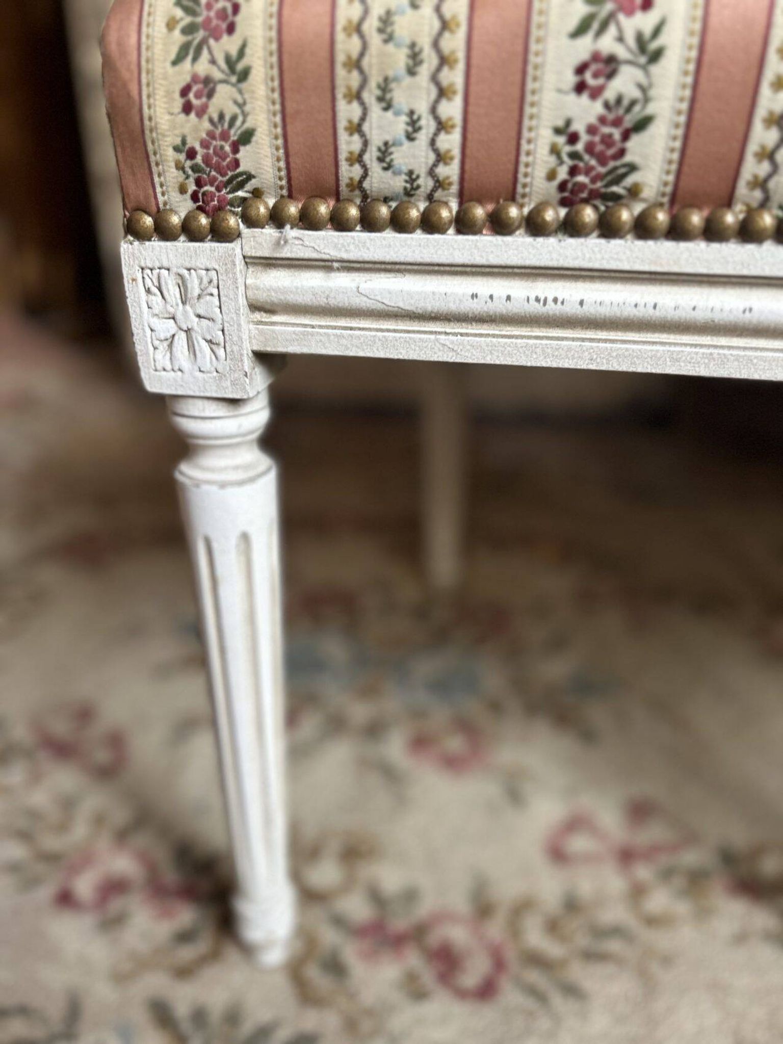 Pair of Louis XVI style chairs in painted wood and satin, classic elegance.