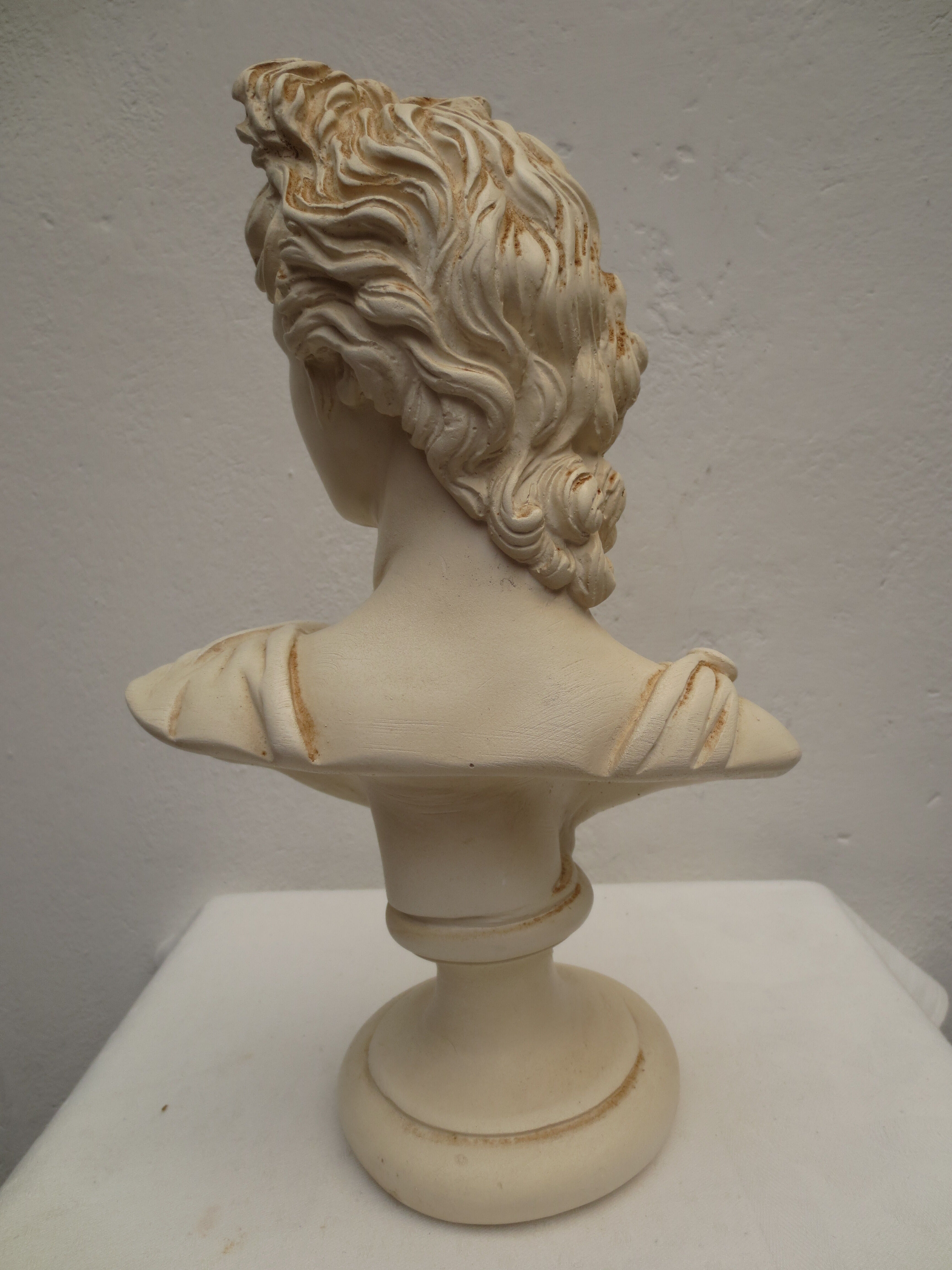 bust of antique subject on pedestal