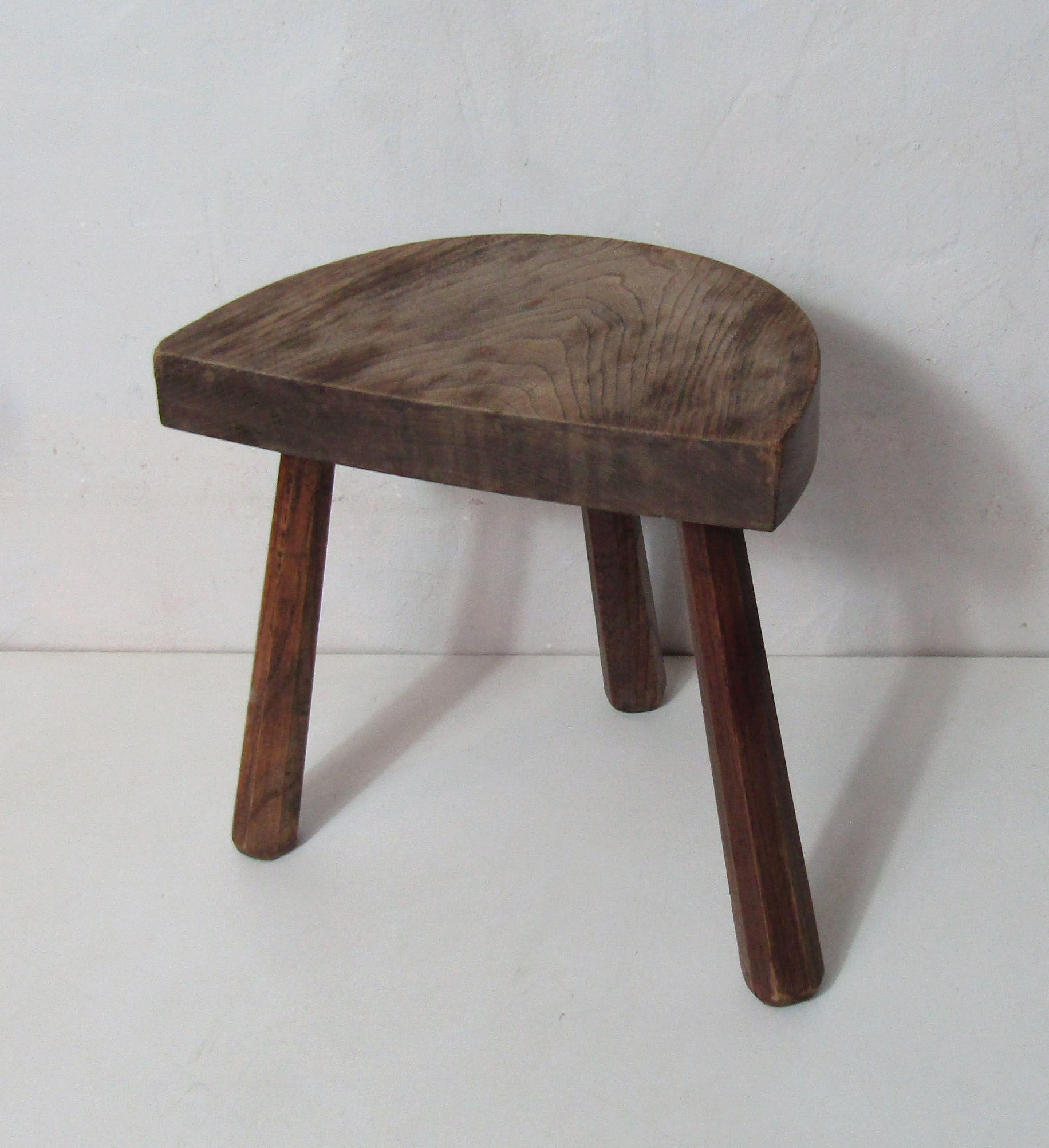 Old half-moon wooden tripod stool