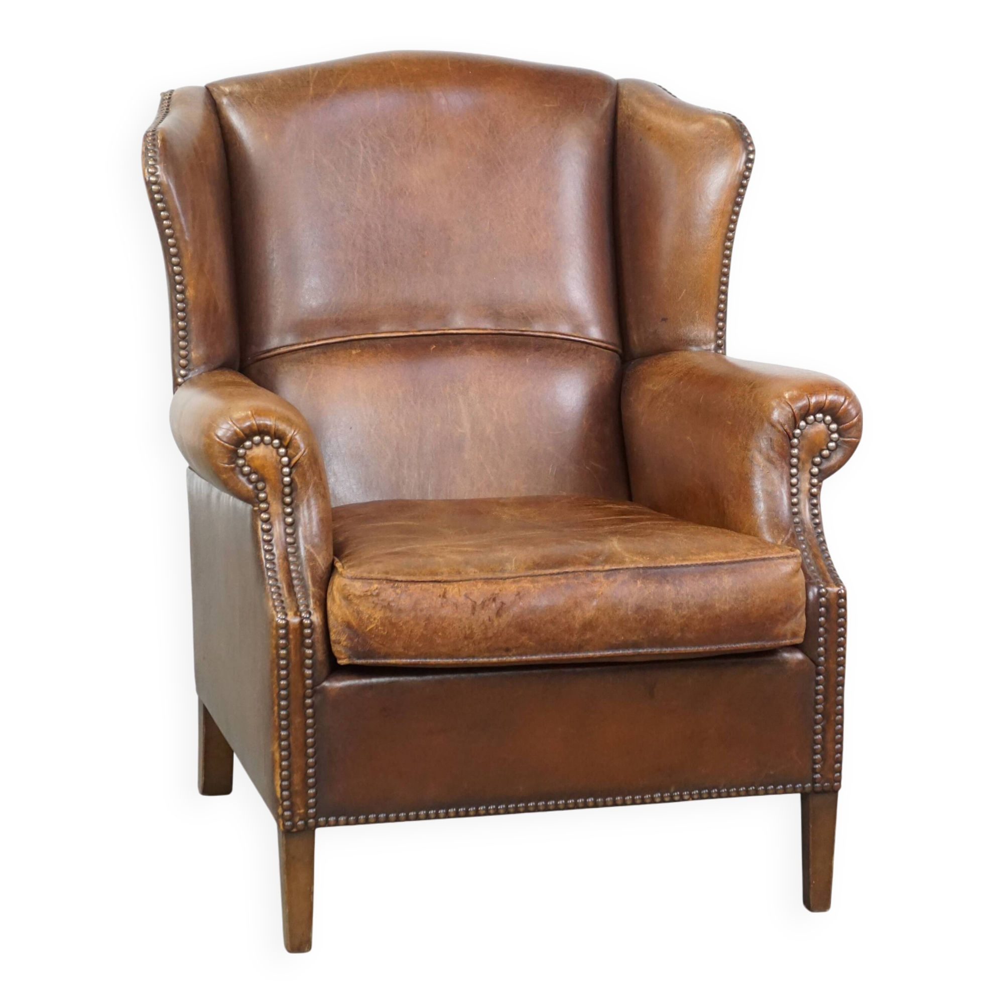 Cognac-colored sheepskin wing chair in English style