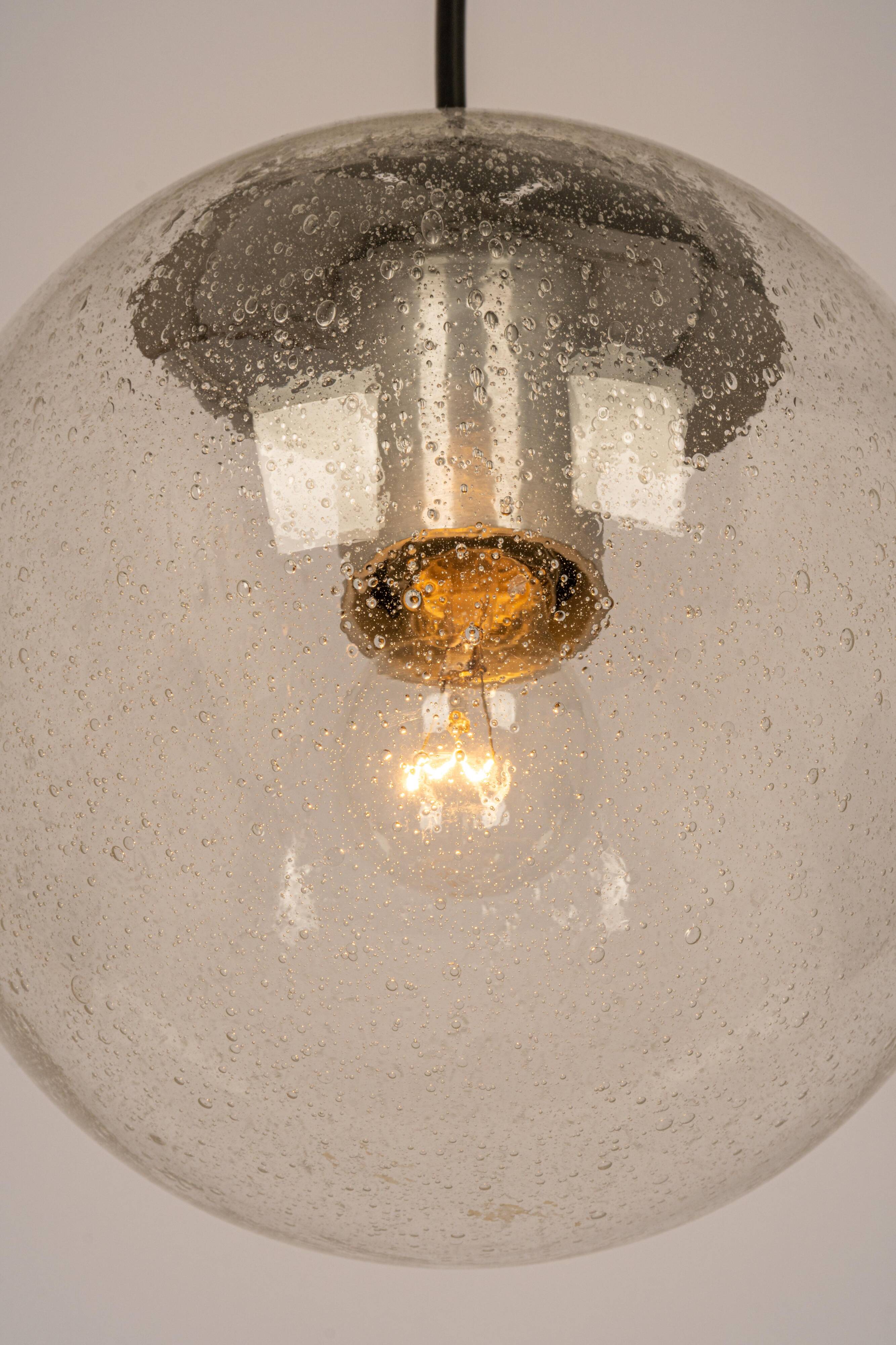 Small Limburg chrome pendant light with transparent glass ball, Germany, 1970s.