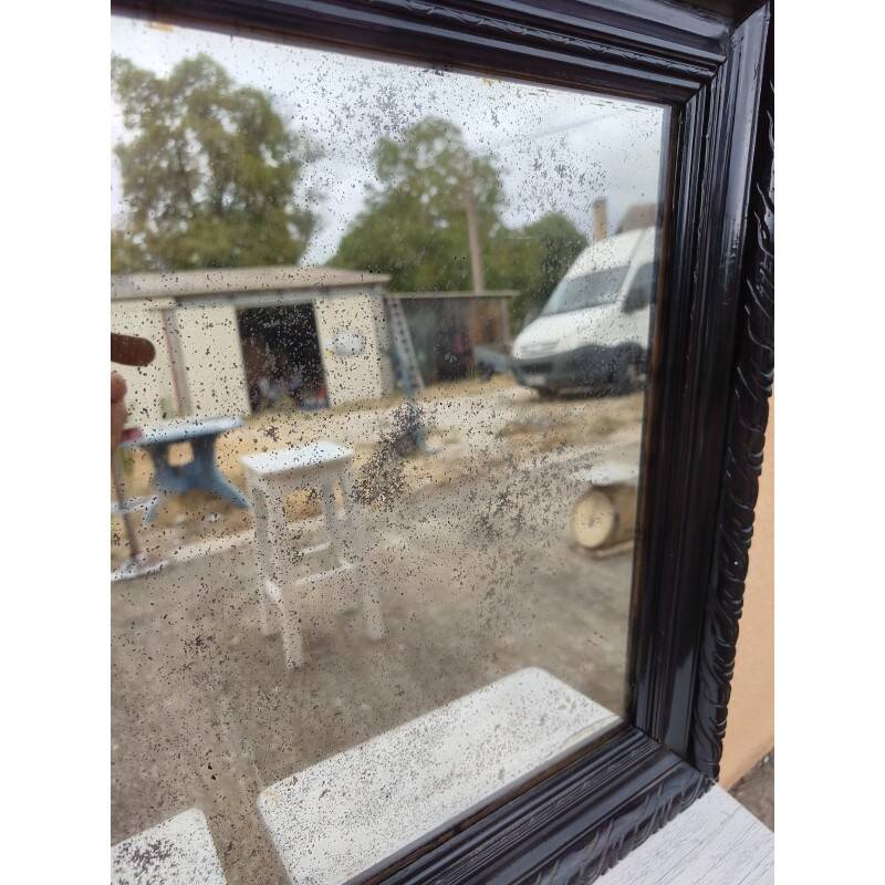 Black lacquered wood mirror "originally punctured"