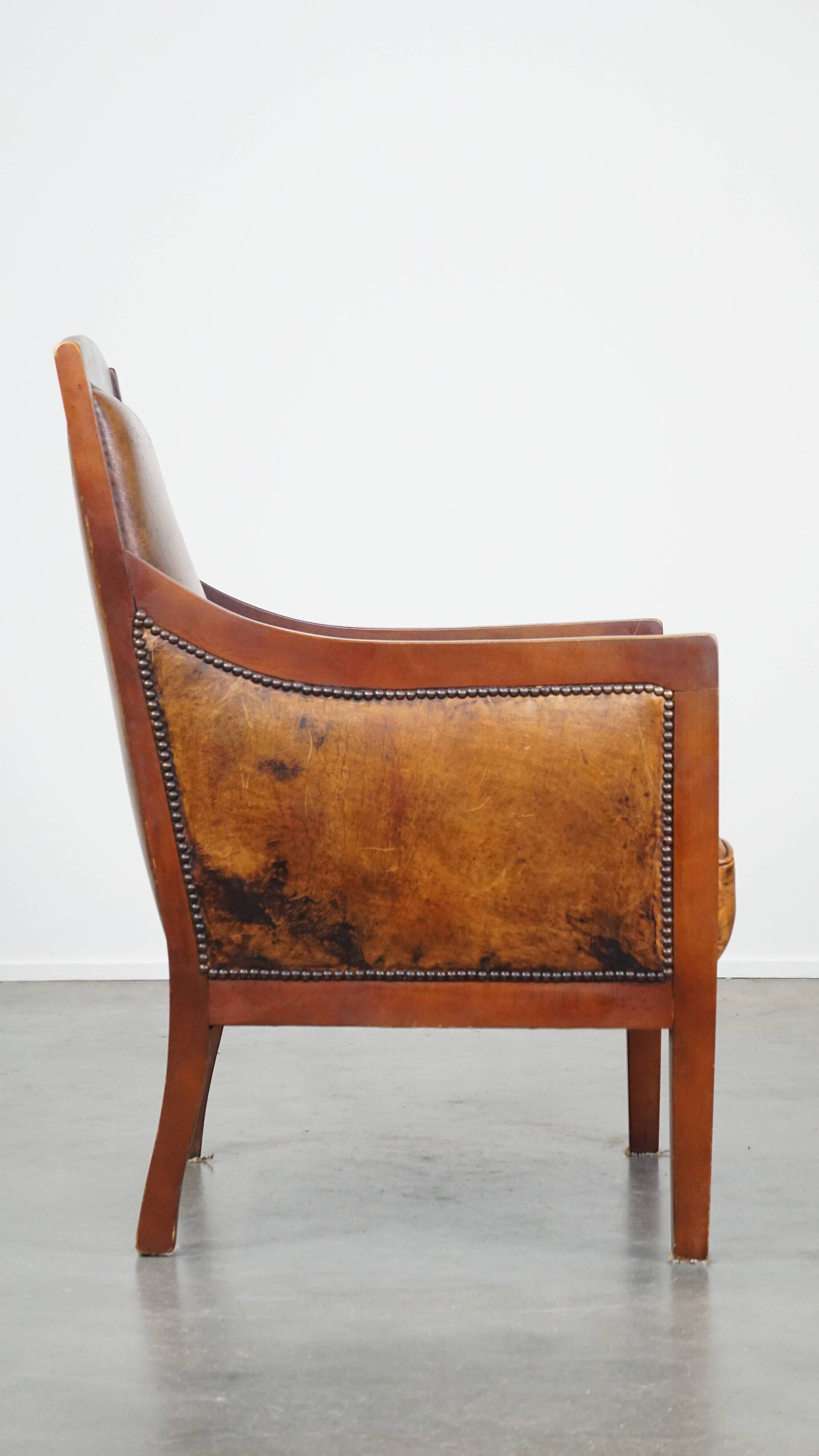 Sheepskin and wooden vintage Art Deco design armchair in a cognac color