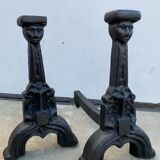 Pair of cast iron chenets with stylized faces High Epoch SEVENTEENTH century