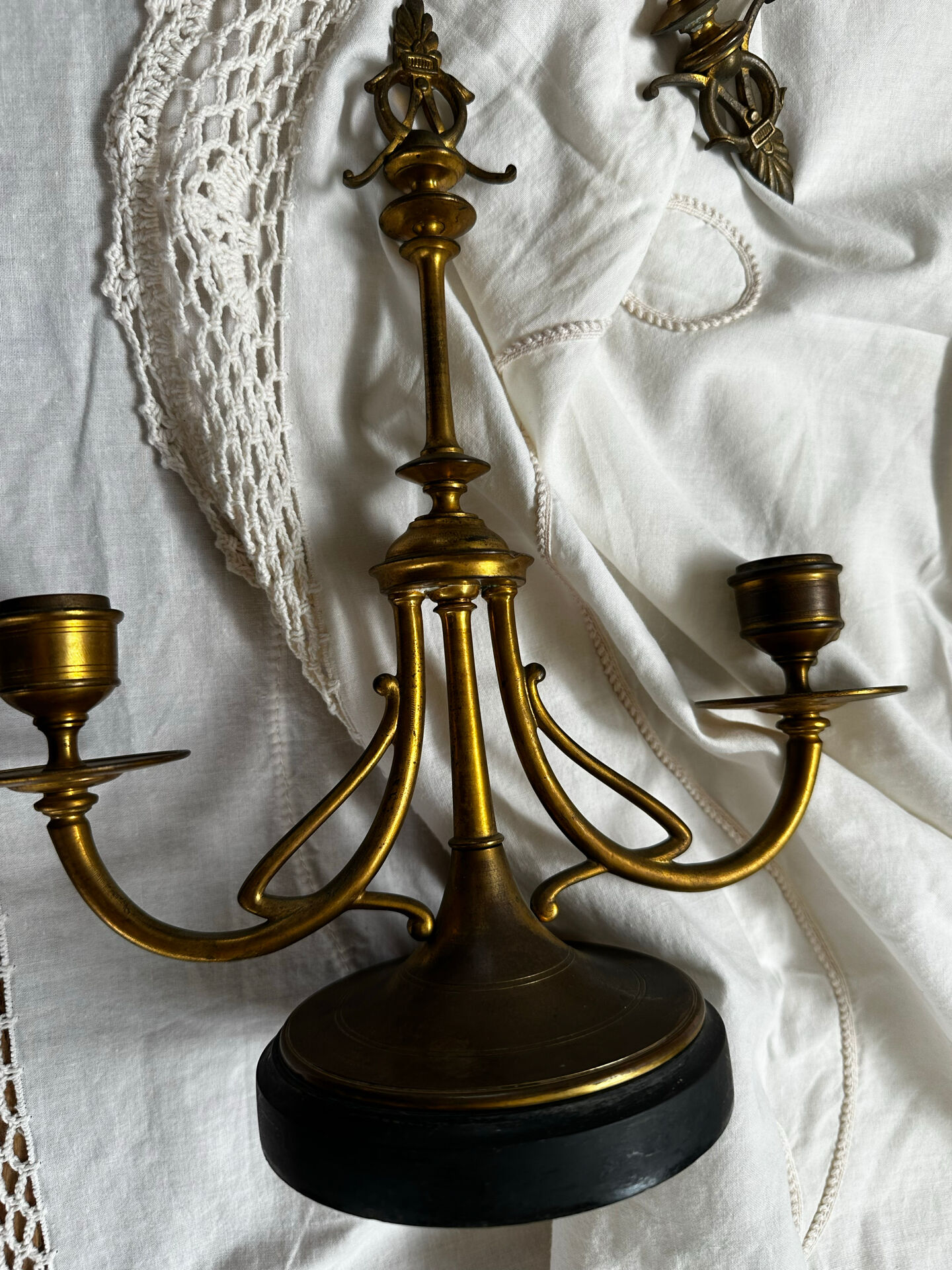 Pair of Empire style candlesticks, patinated brass and black stone.