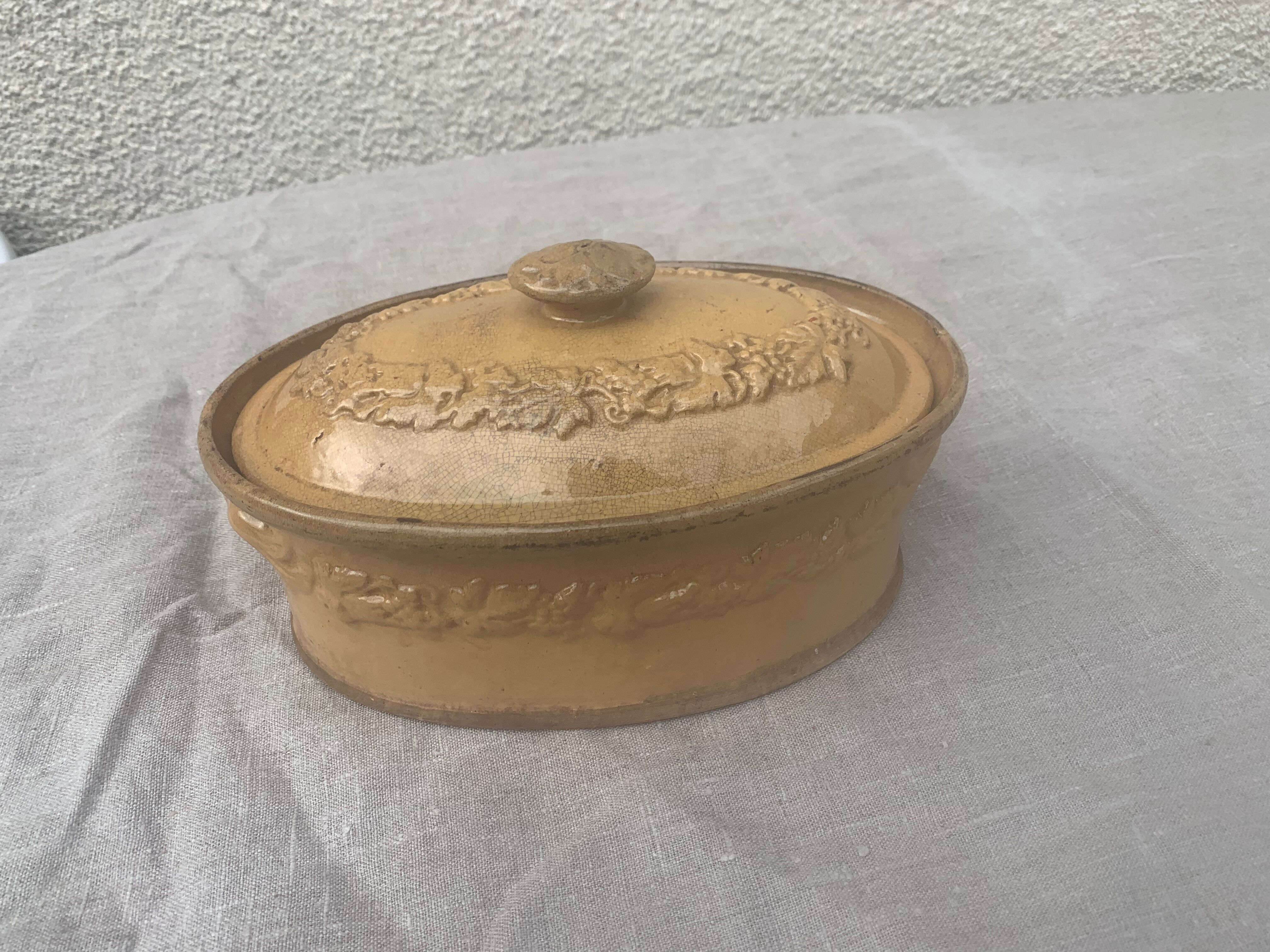 Old terrine in glazed stoneware and floral decoration mustard yellow slip