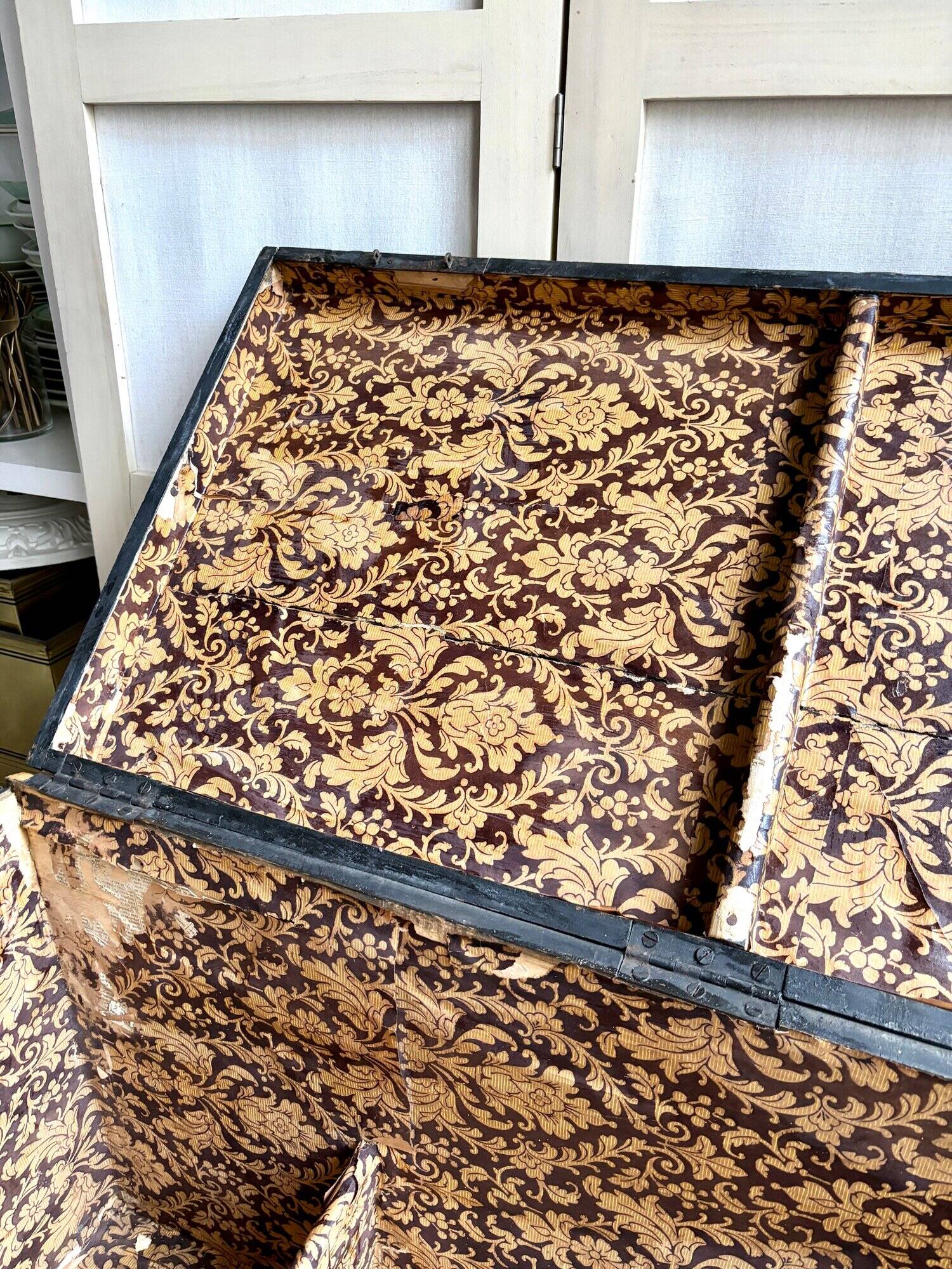 Trunk, black wooden chest and wallpaper