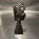 Ceramic sculpture representing a woman's face placed on a black base