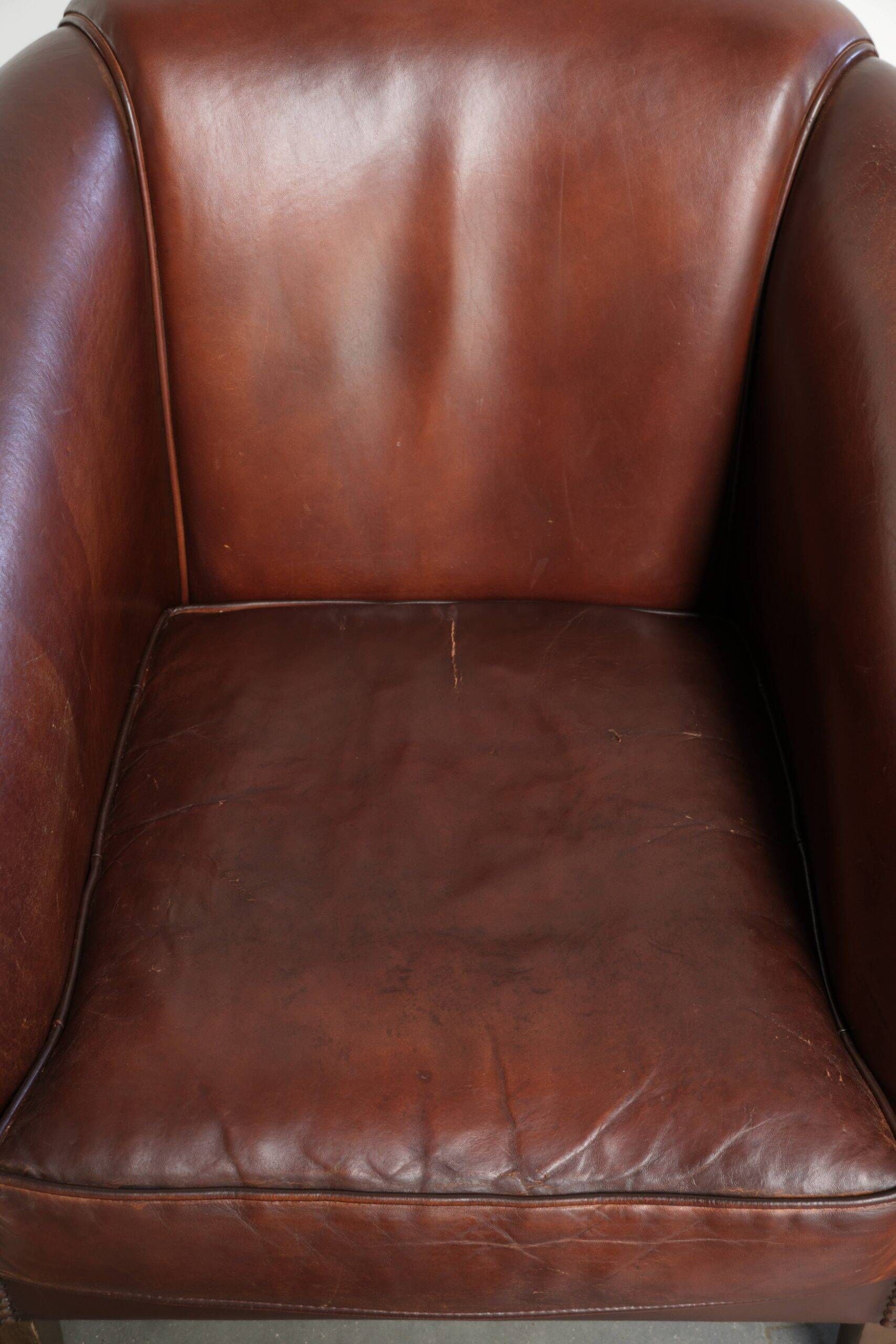 Set of 2 sheepskin club armchairs in a dark cognac colour