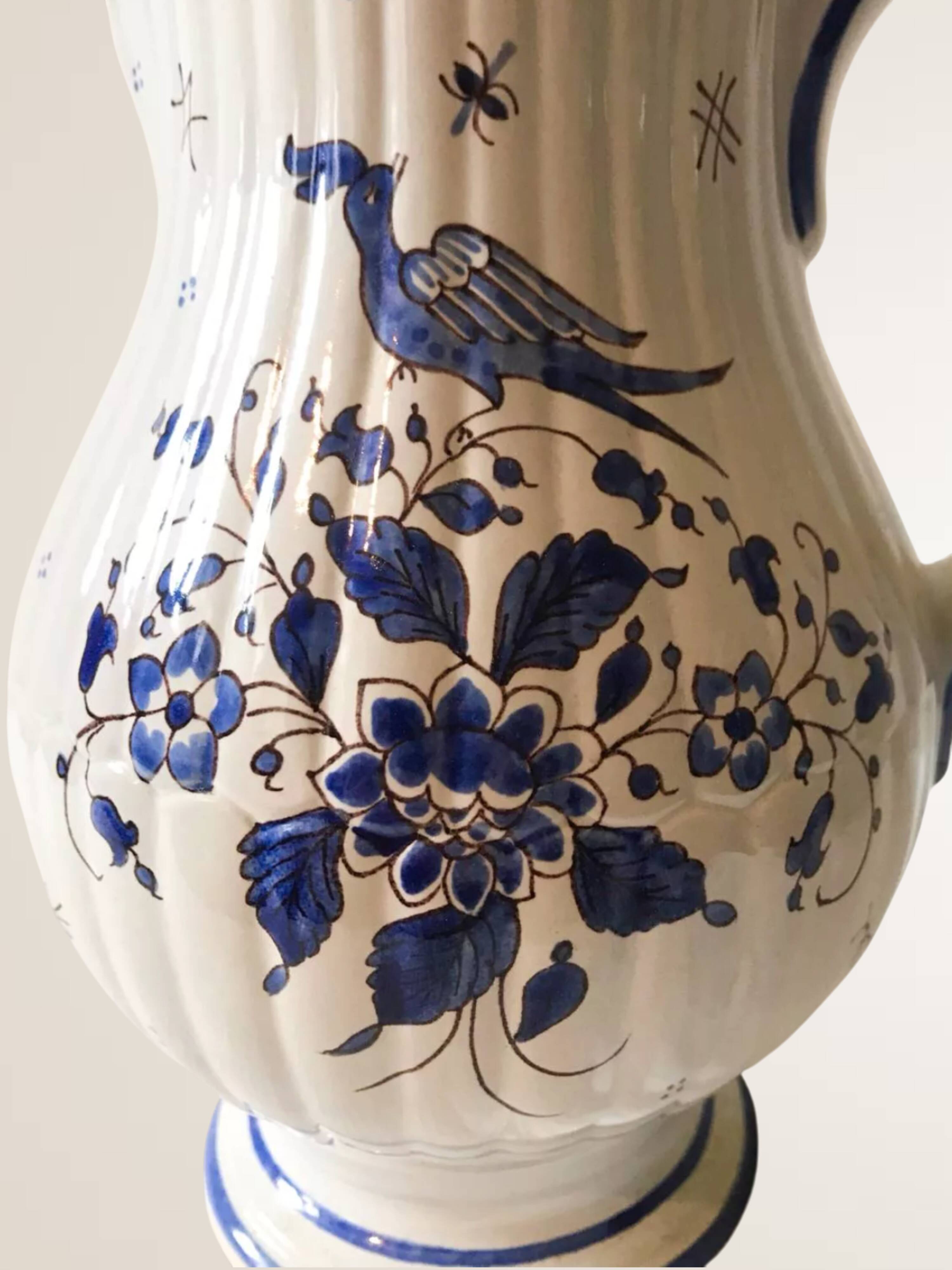 Moutiers earthenware jug, hand-painted blue decoration.