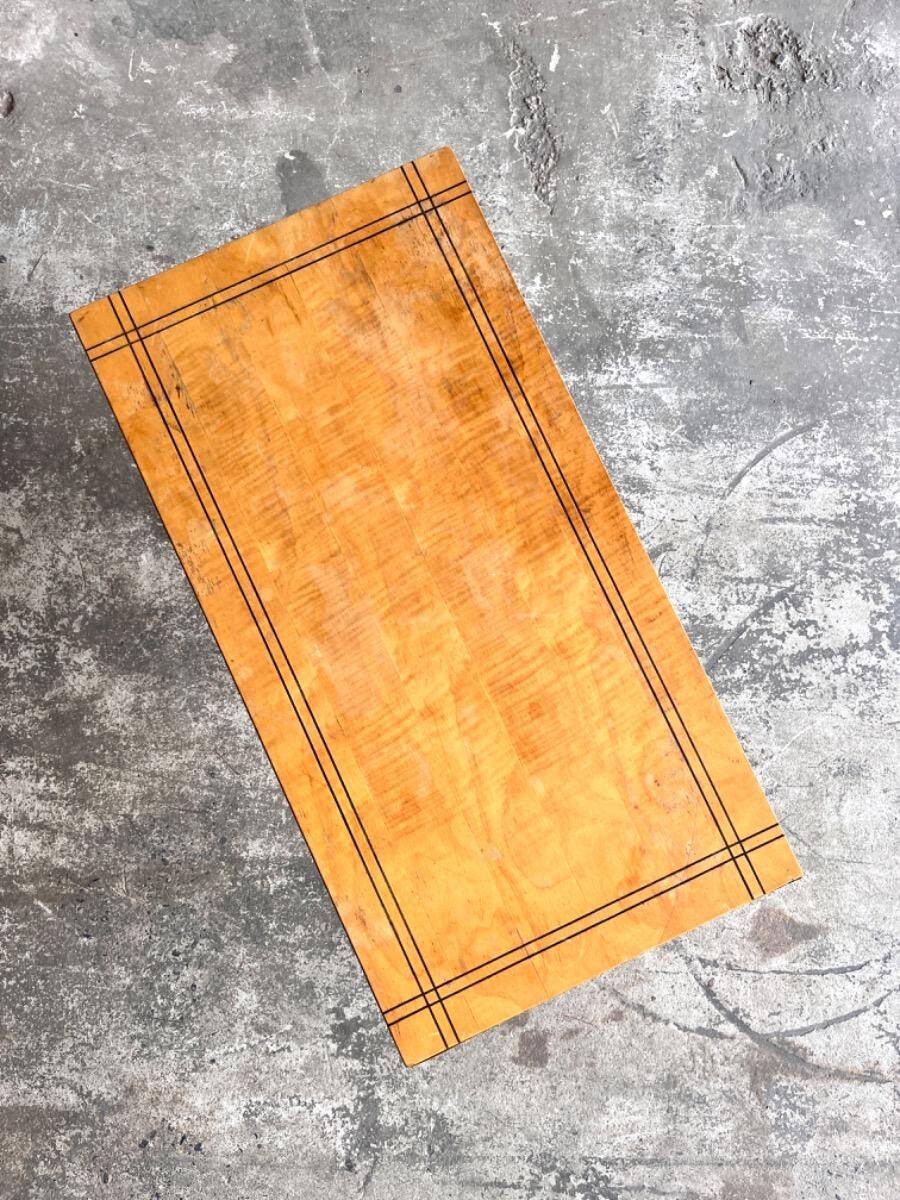 Vintage coffee table with gold-gilded legs and light brown wood veneer geometric inlaid top