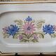 Rectangular earthenware dish with a glazed finish, decorated with a bouquet of flowers.