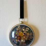 Vintage medallion of dried flowers decorative frame in domed glass and brass