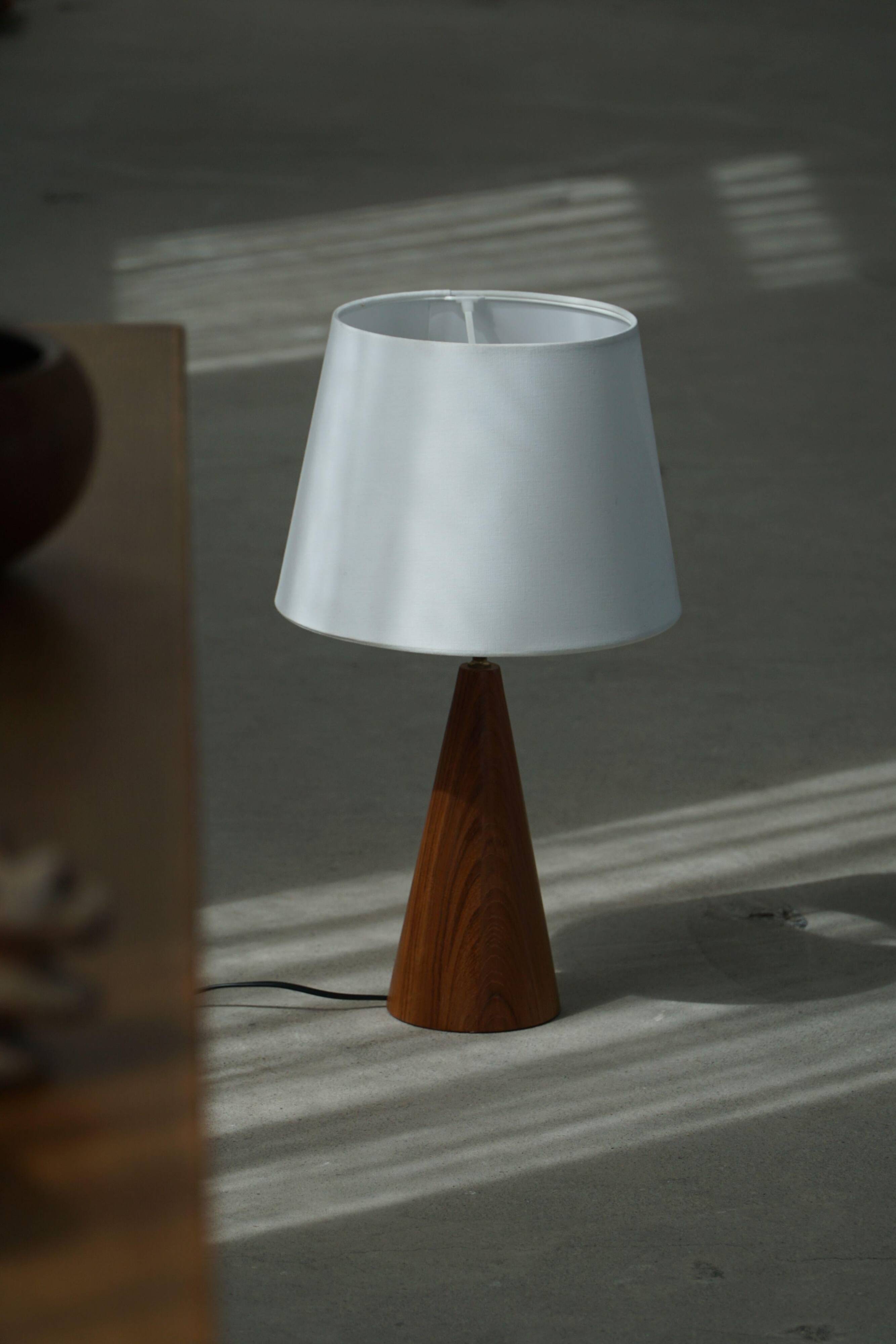 Modern Danish, a conical table lamp in teak, 1980s.