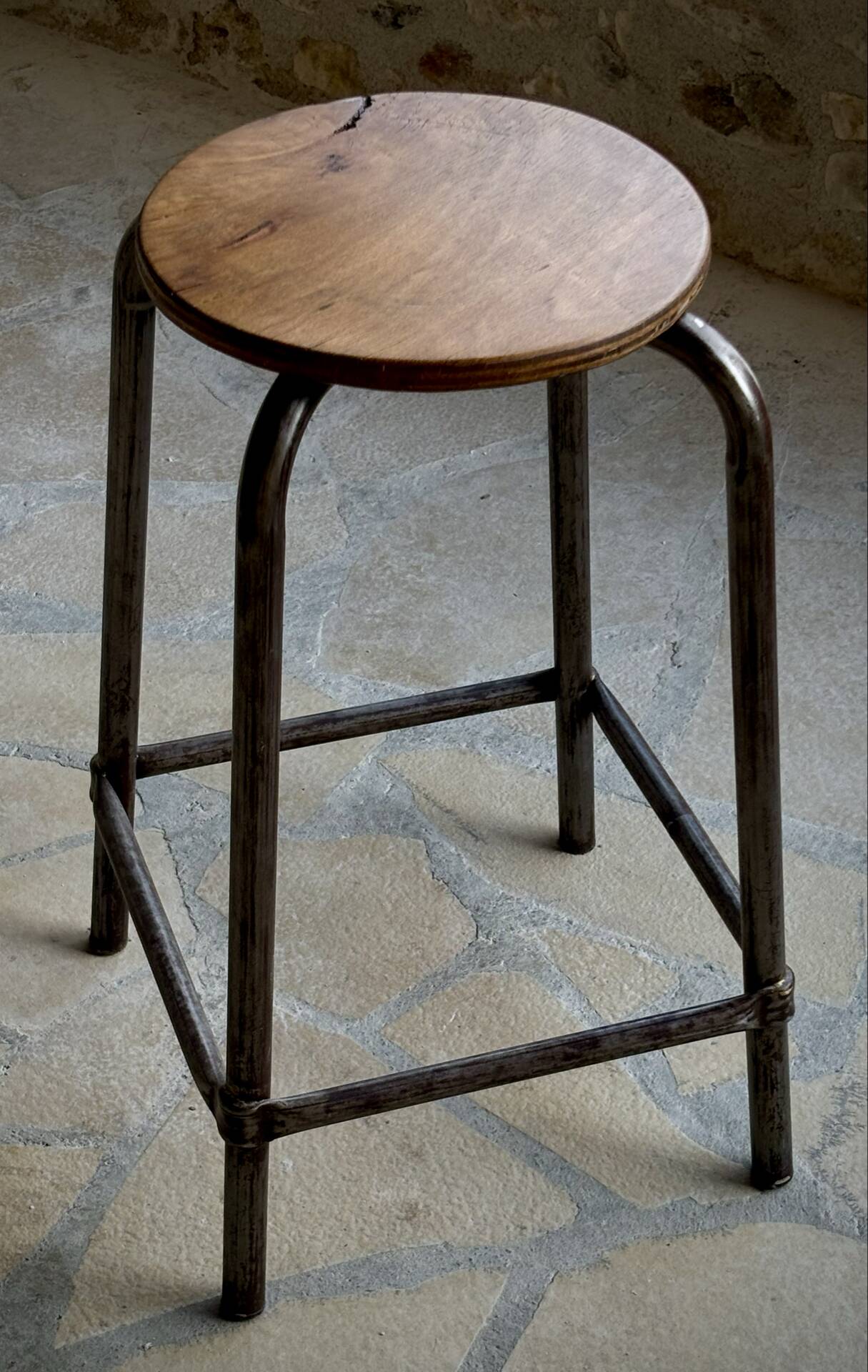 Old workshop stool in steel and beech