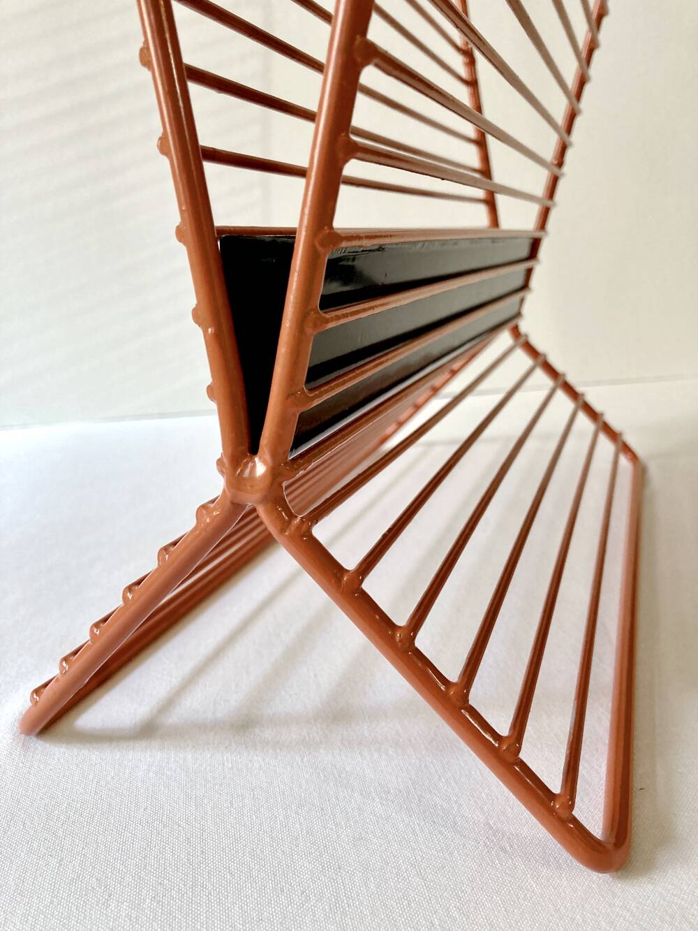 Wire metal magazine rack with triangular compartment, 1950s.