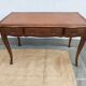 Louis XV style desk in wood, with a brown leather top.