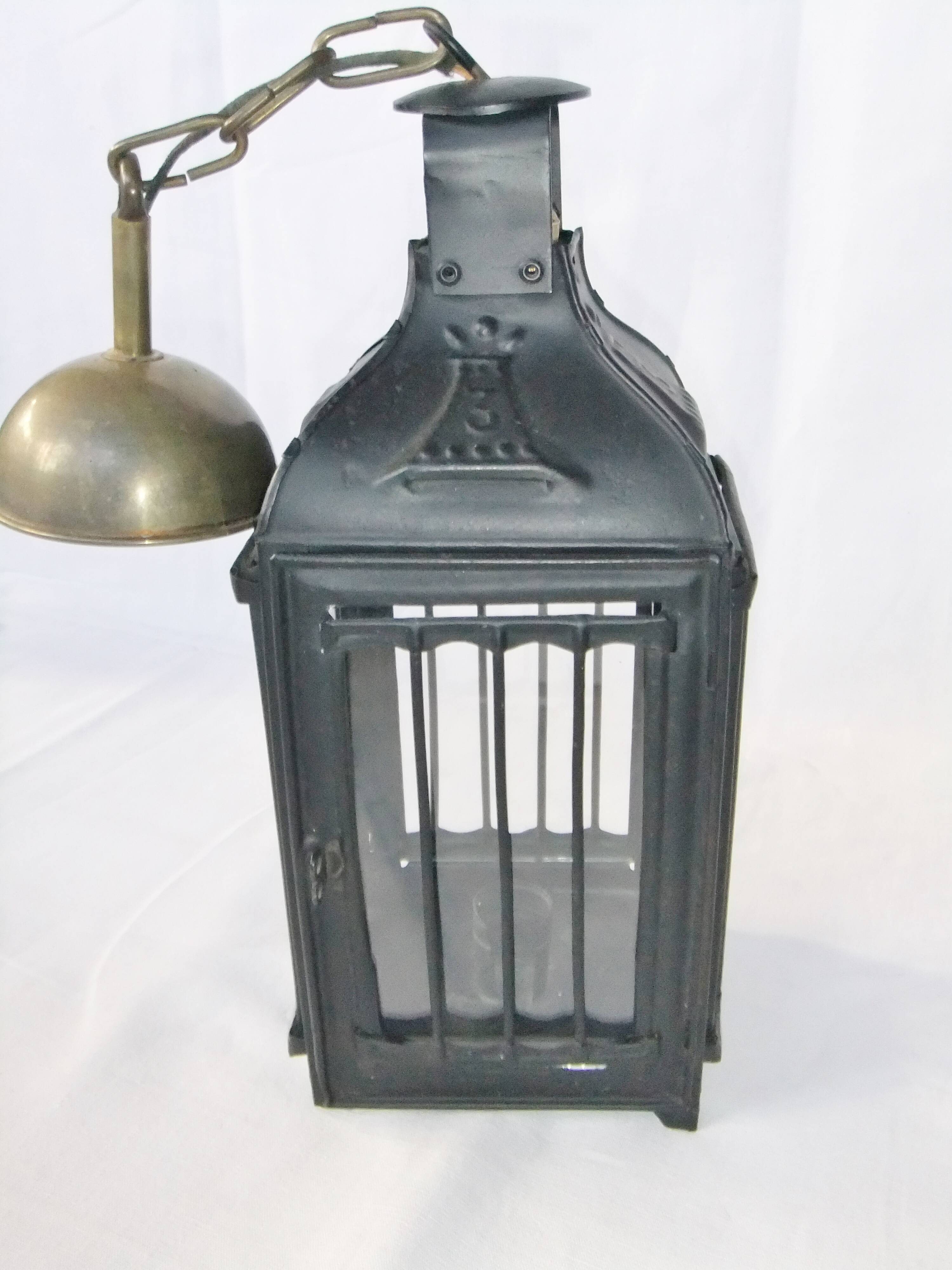 Old chandelier hanging lantern with candle in sheet metal