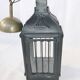 Old chandelier hanging lantern with candle in sheet metal