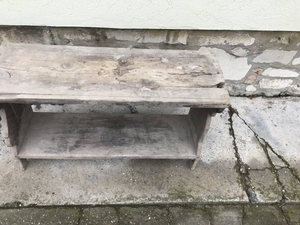 Small country bench in grey pine, rustic antique style with storage shelf.