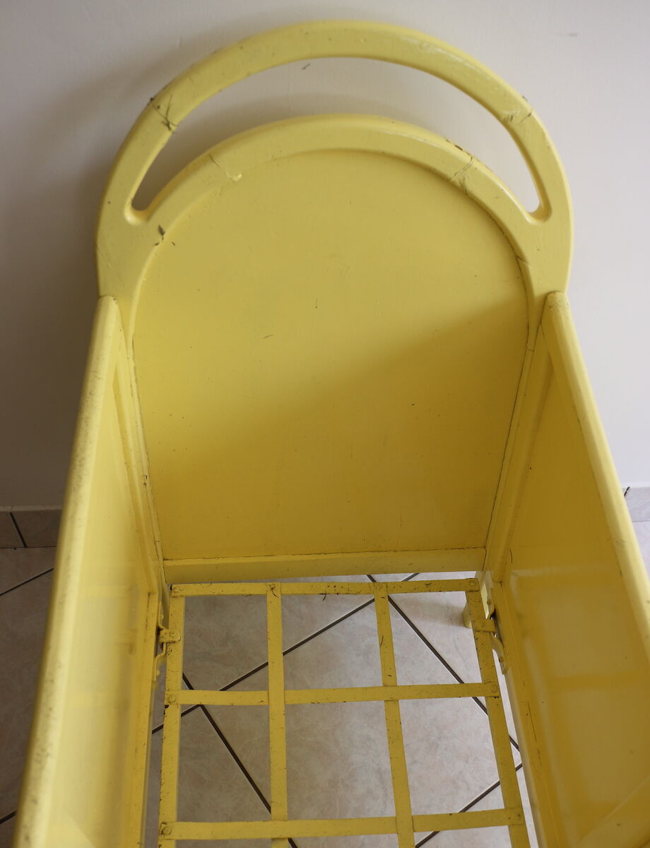 Yellow vintage baby cot