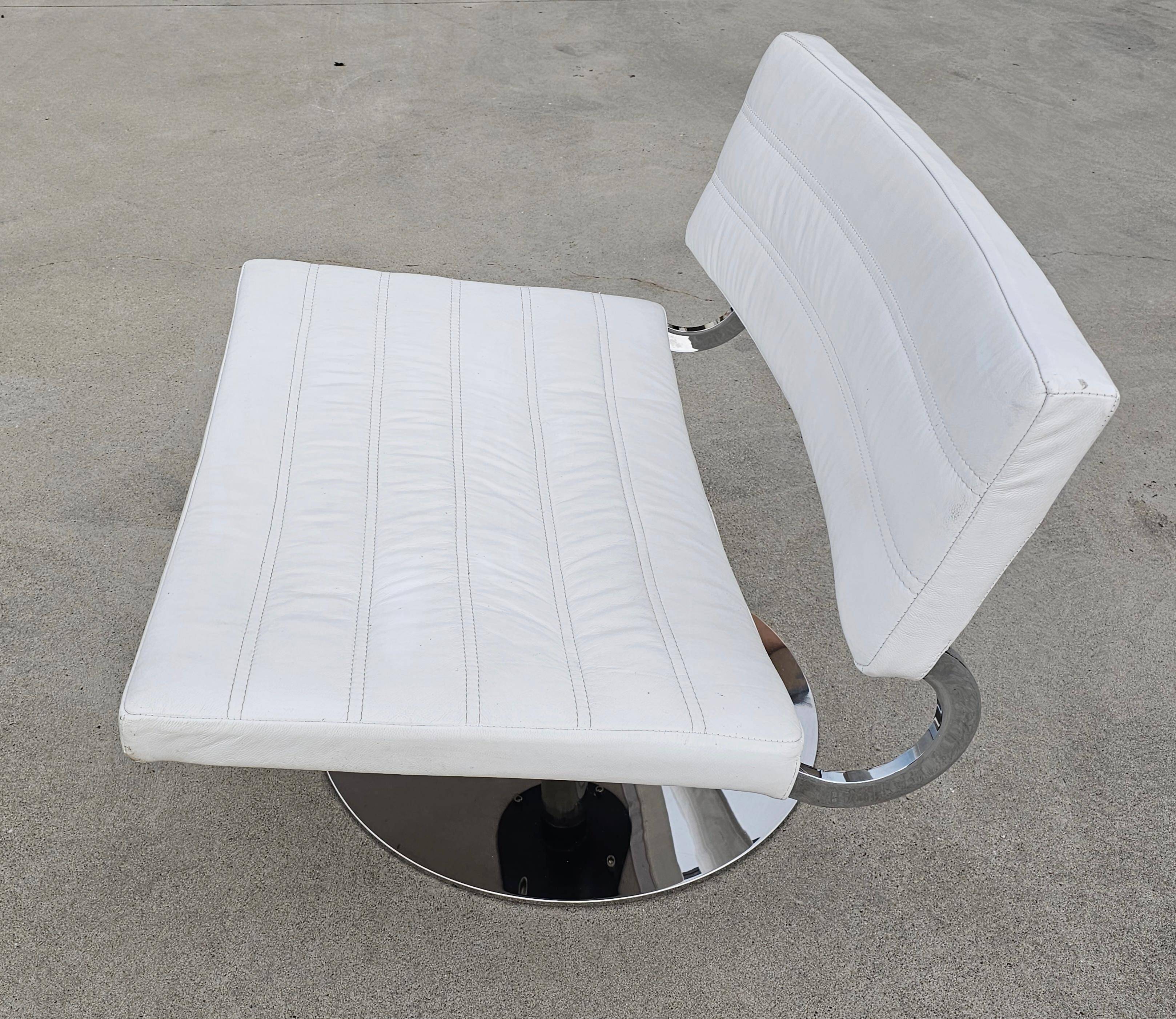 Pair of postmodern swivel armchairs in leather and chrome, Italy 1970s.