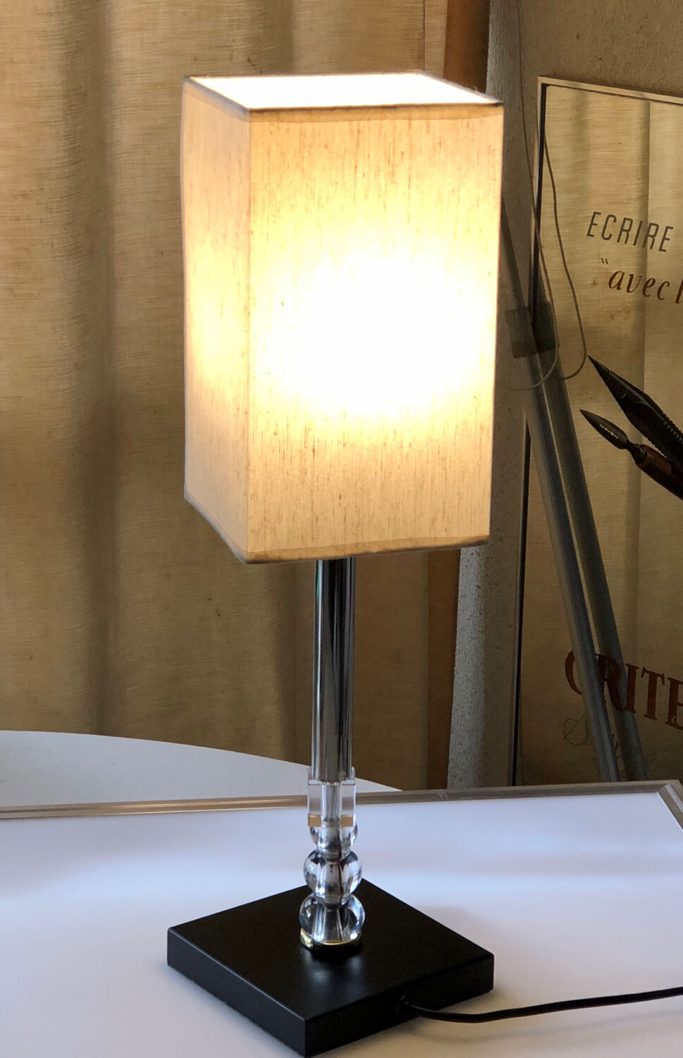 Silver floor lamp with a straight shade.