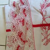 Large white tablecloth and red handmade embroidery. Lace surround;