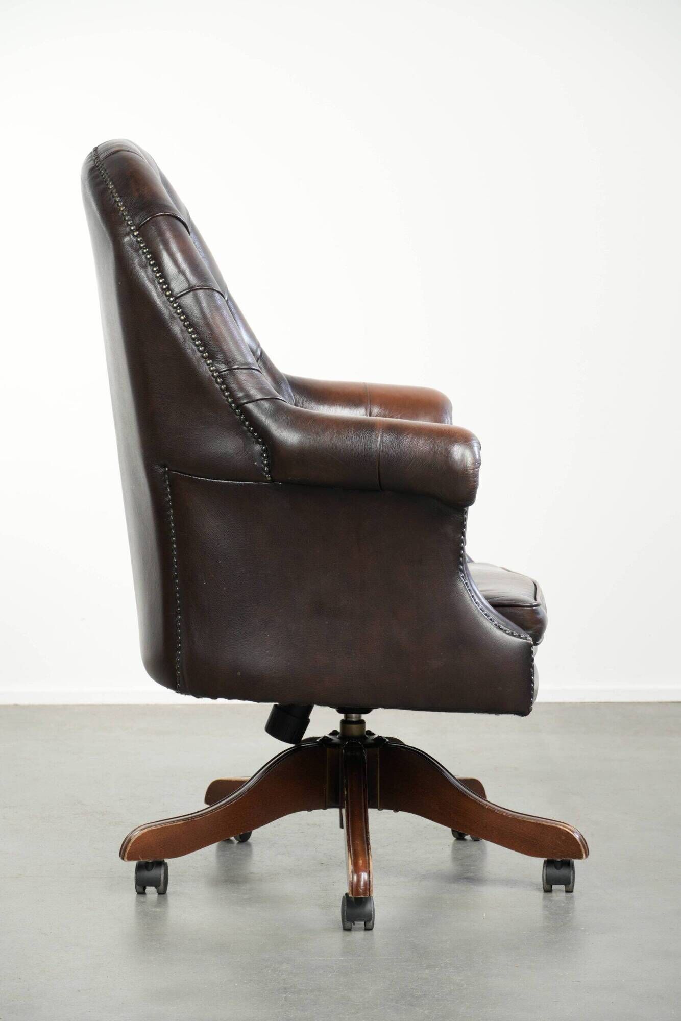 Brown cow leather Chesterfield office chair on wheels in English style