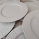 Set of 7 flat plates in white Limoges porcelain geometric decoration in relief