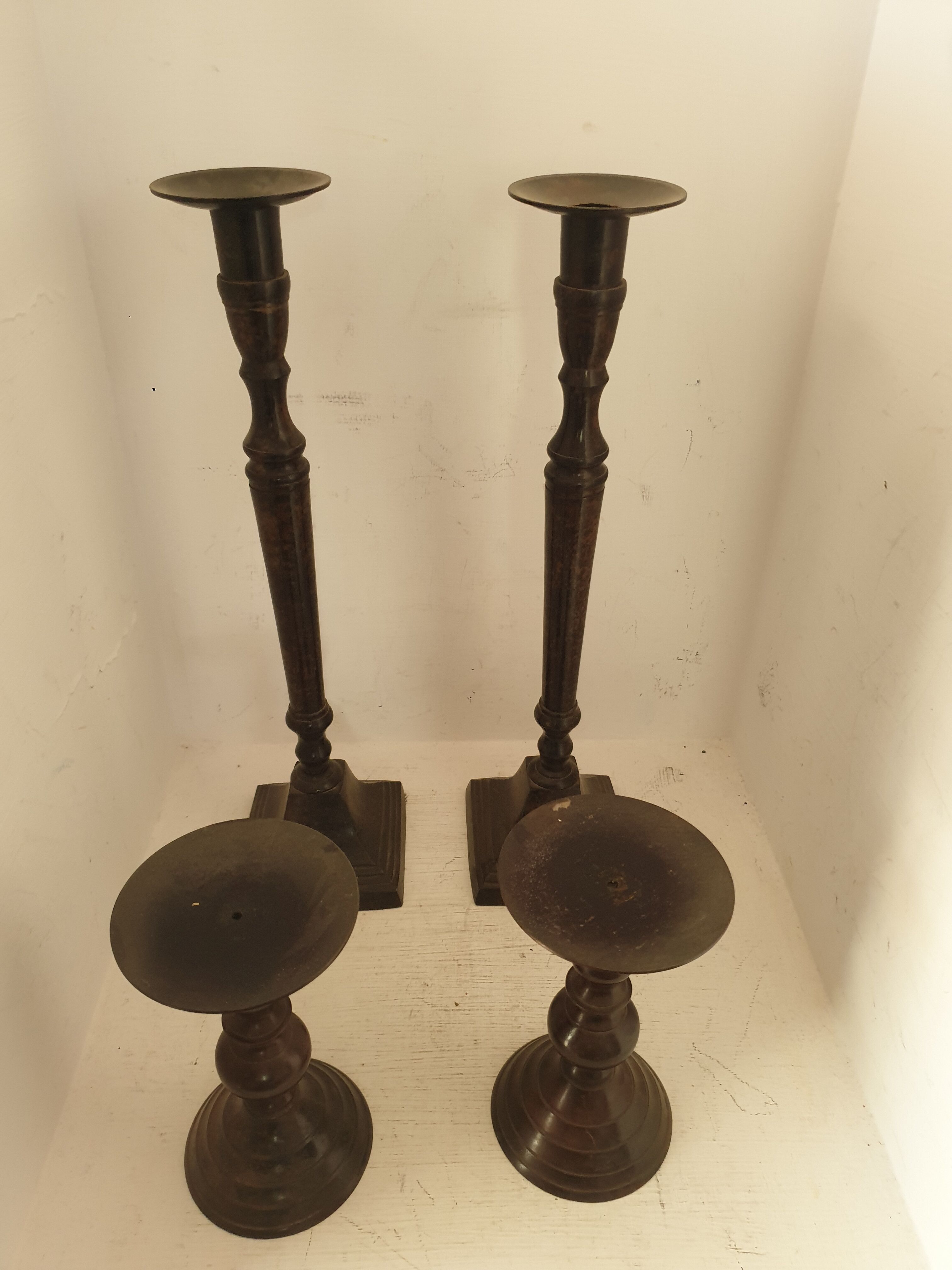 Two pairs of patinated brass candle holders