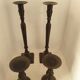 Two pairs of patinated brass candle holders