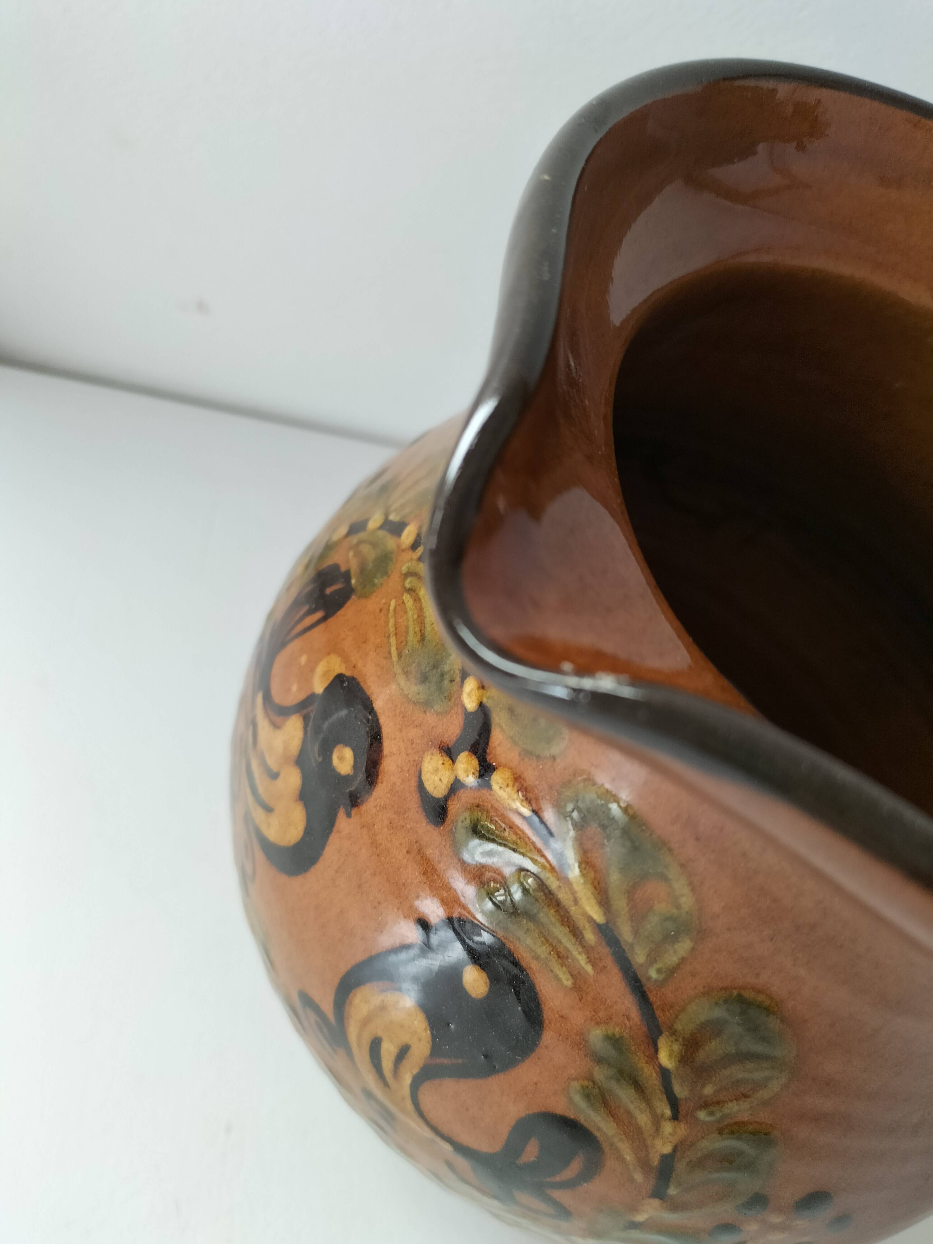 Glazed earthenware pitcher signed HR with a design of stylised birds.