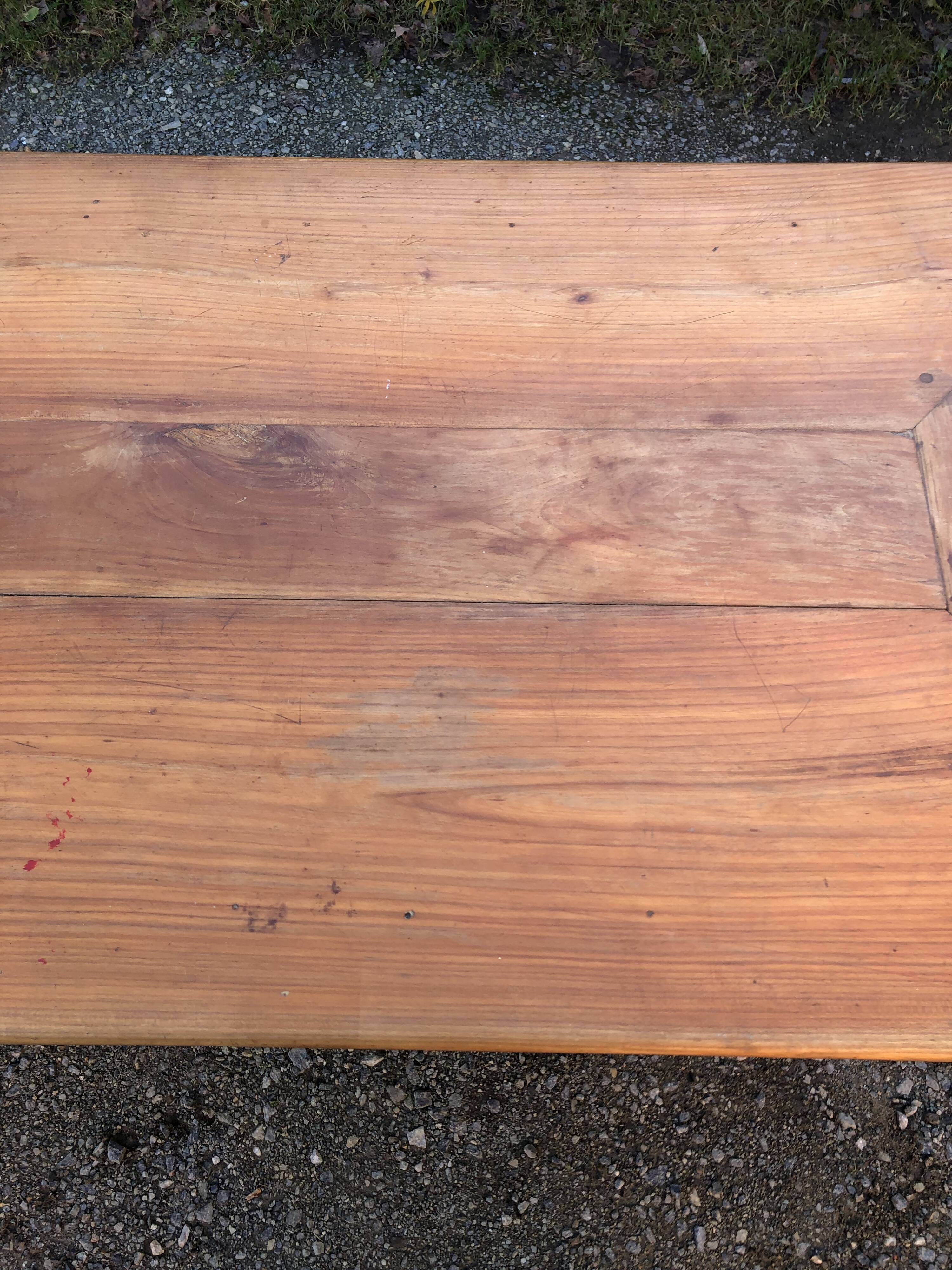 Antique cherry farmhouse table with turned legs and 2 drawers.