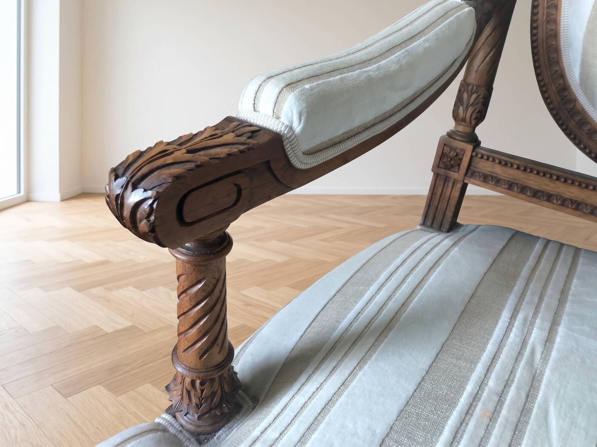 Louis XV style classic canapé reupholstered in striped beige fabric.