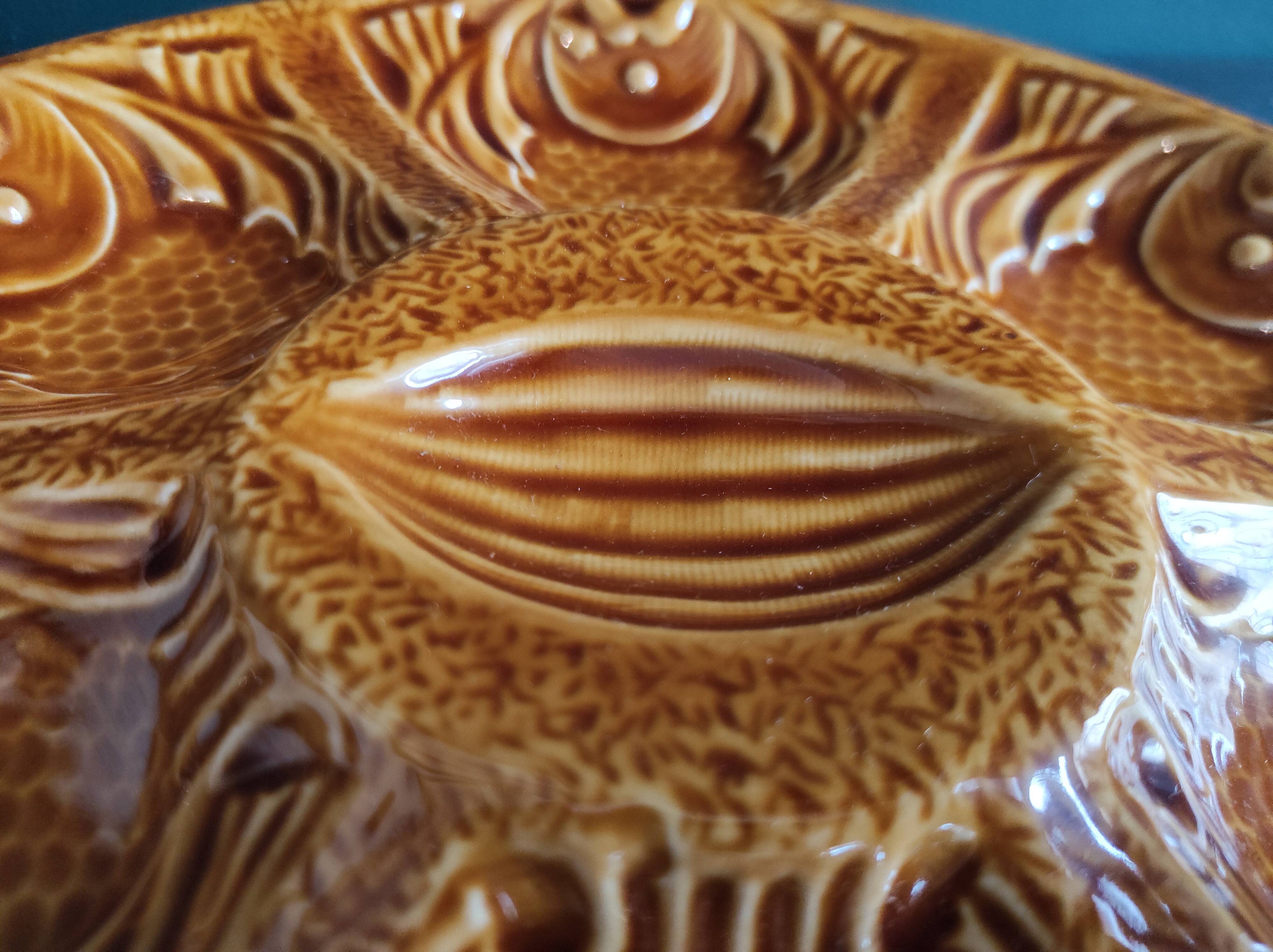 Vintage French amber oyster plate in Majolica decorated with fishes