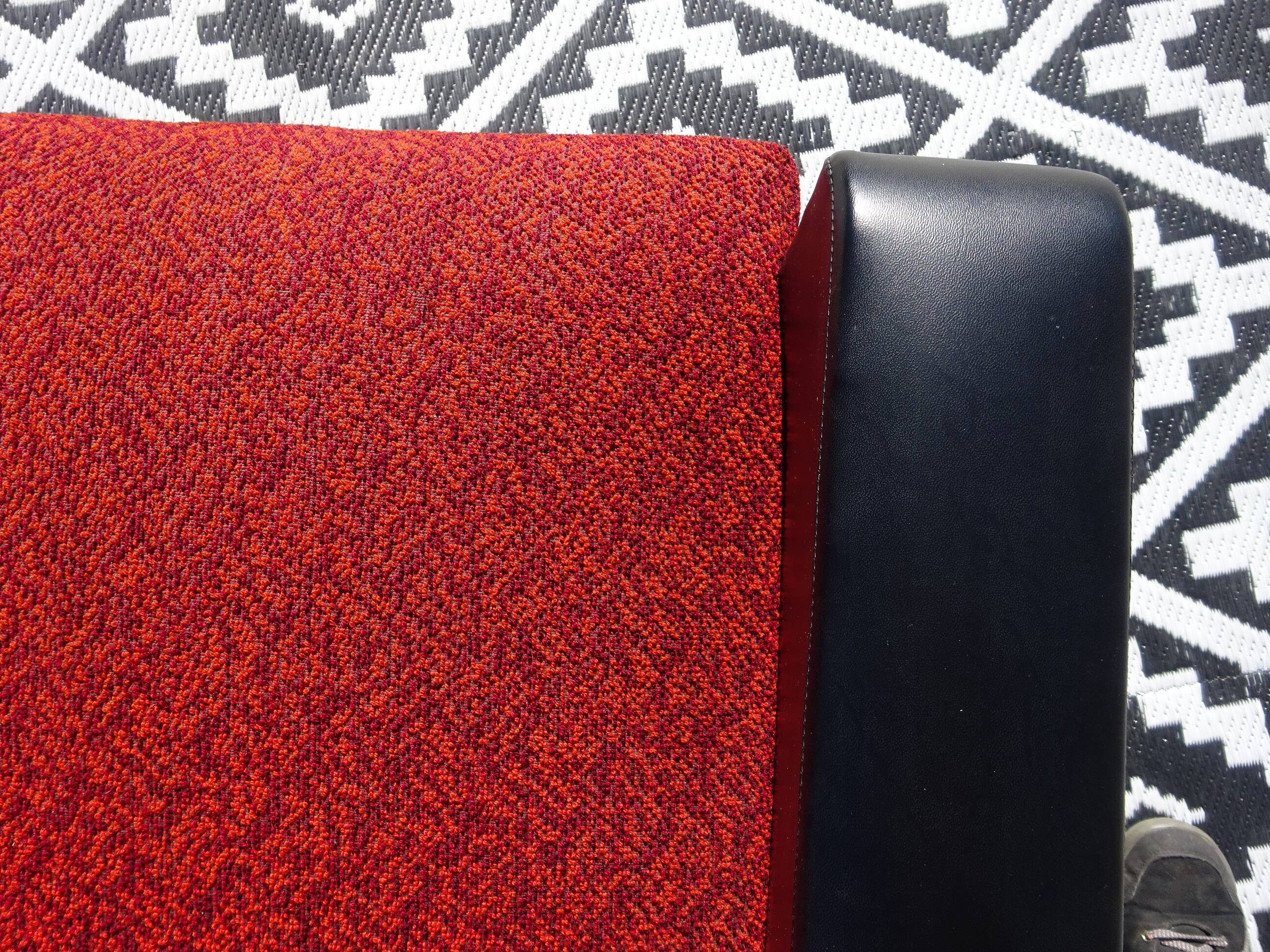 Vintage armchairs in red and black faux leather, the pair.
