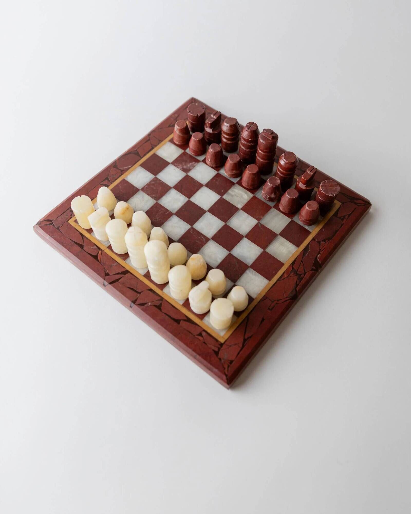 Vintage marble chess set from the 1960s, cream, burgundy and gold board with metal inlay, stone pieces.