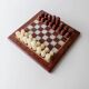 Vintage marble chess set from the 1960s, cream, burgundy and gold board with metal inlay, stone pieces.