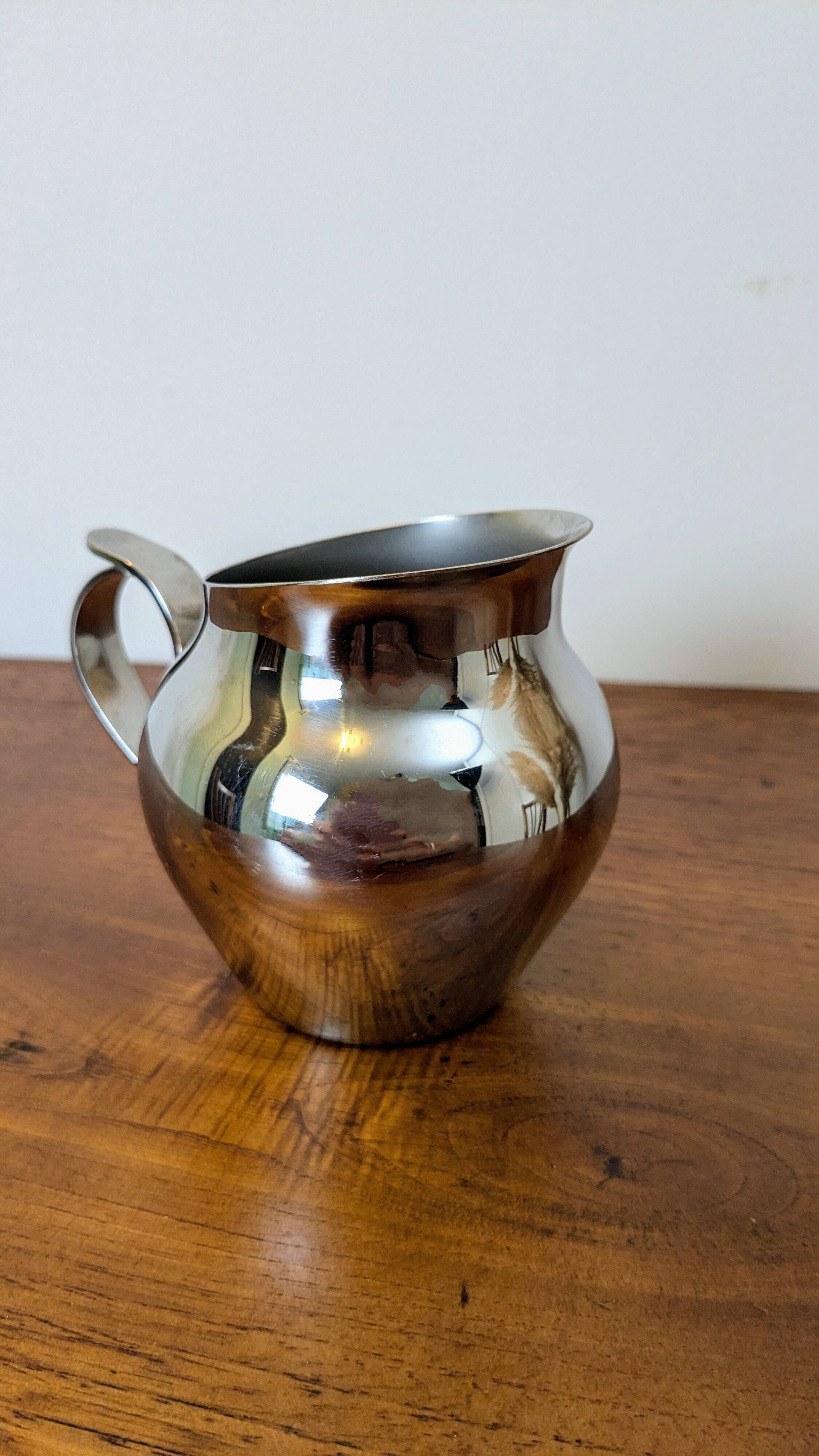 Antique stainless steel milk jug by Remy Letang