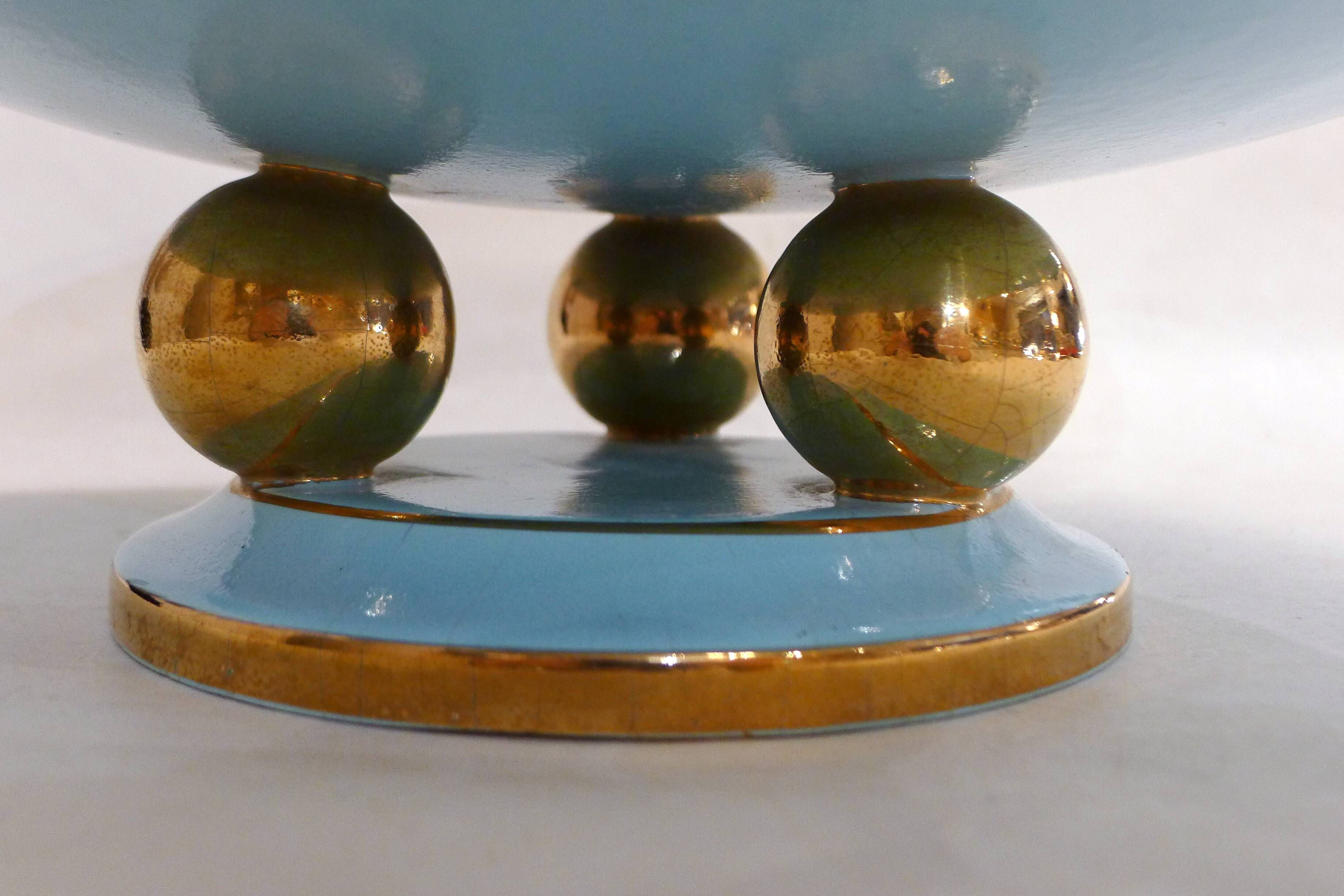 Art Deco modernist coupe, with a base of 3 spheres, in turquoise ceramic and gilding.