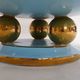 Art Deco modernist coupe, with a base of 3 spheres, in turquoise ceramic and gilding.