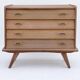 Renovated vintage commode from the 1960s in oak with slanted profile and tapered legs.