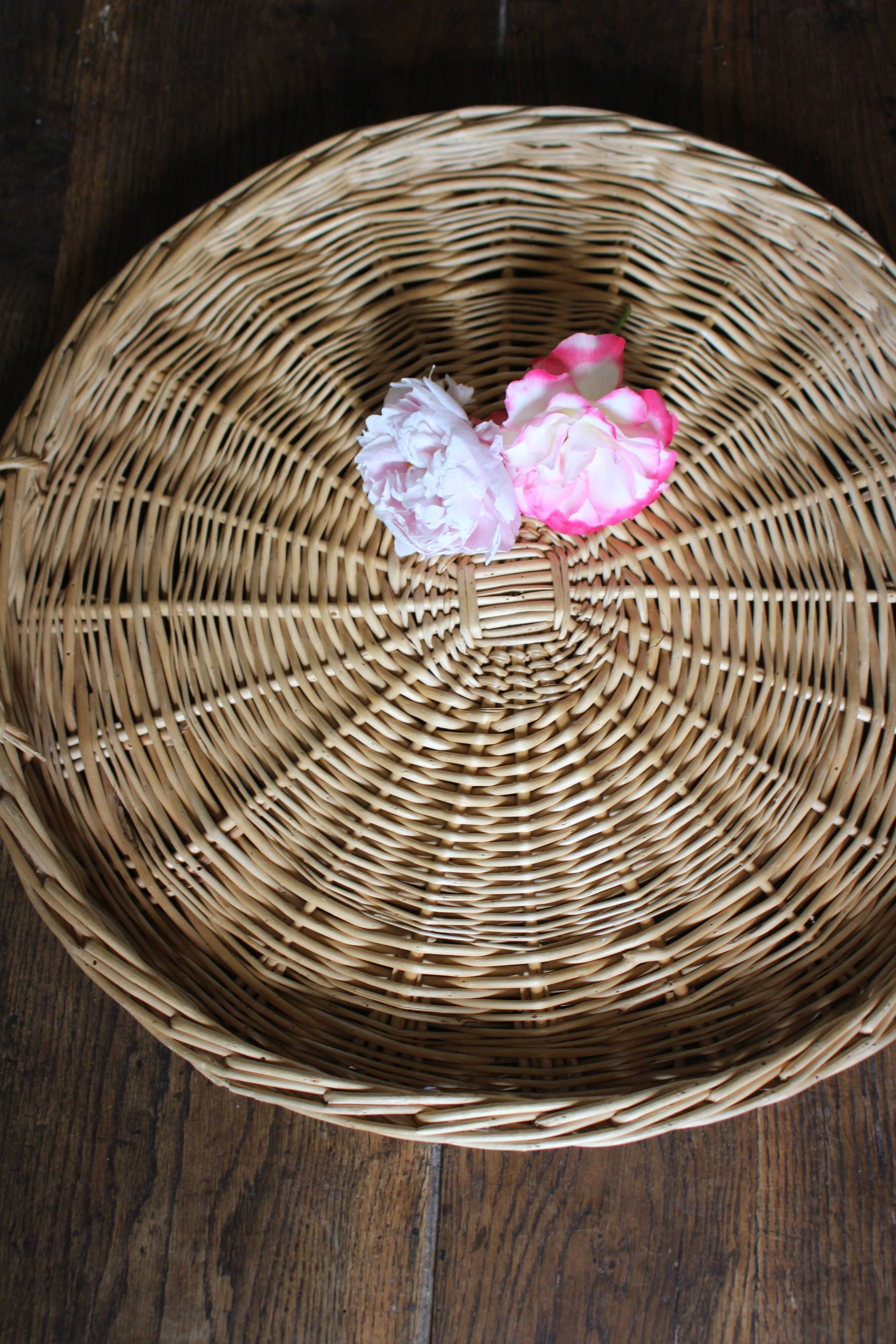 Large round wicker tray with two handles, vintage weaving.