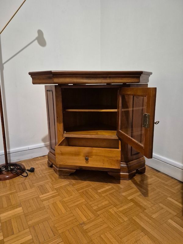 Wooden TV unit with a rotating top.